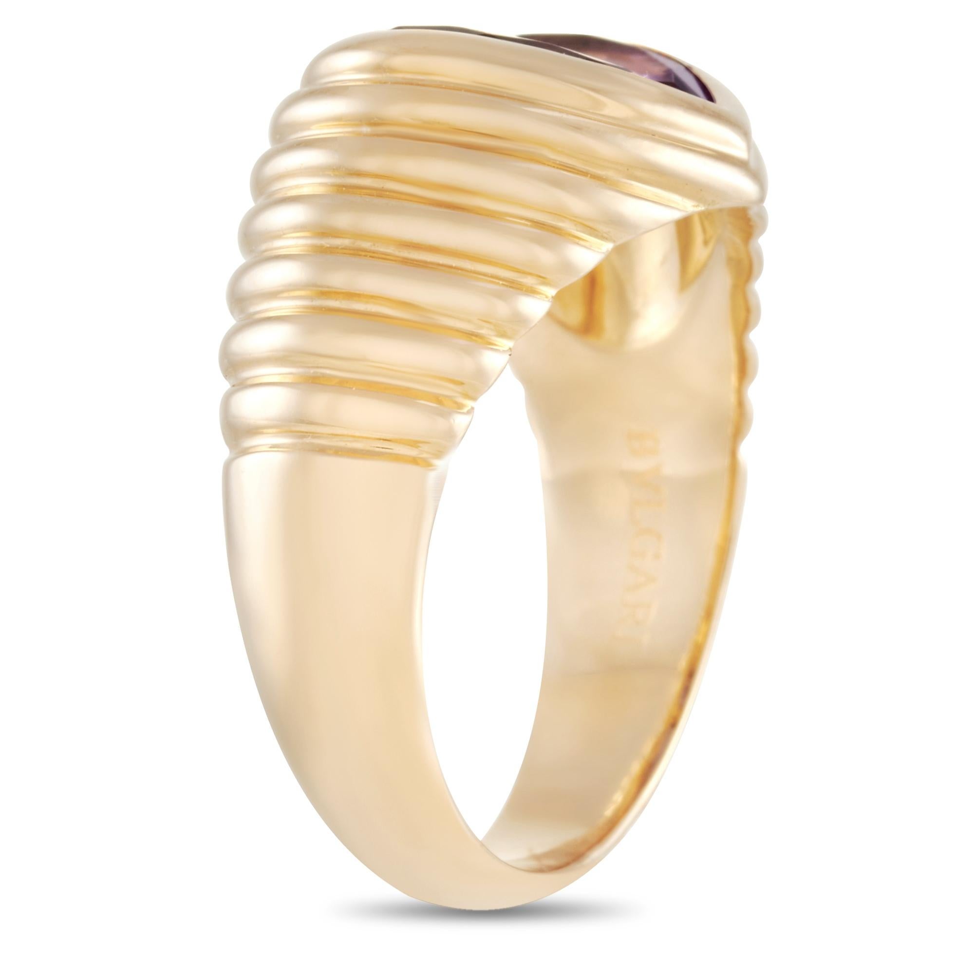 A statement ring ready to captivate you with its bejeweled charm. The Bvlgari 18K Yellow Gold Doppio Ring features a textured 5mm yellow gold band set with an amethyst gemstone. The ring weighs 9.2 grams and has a top height of 4mm. Its top