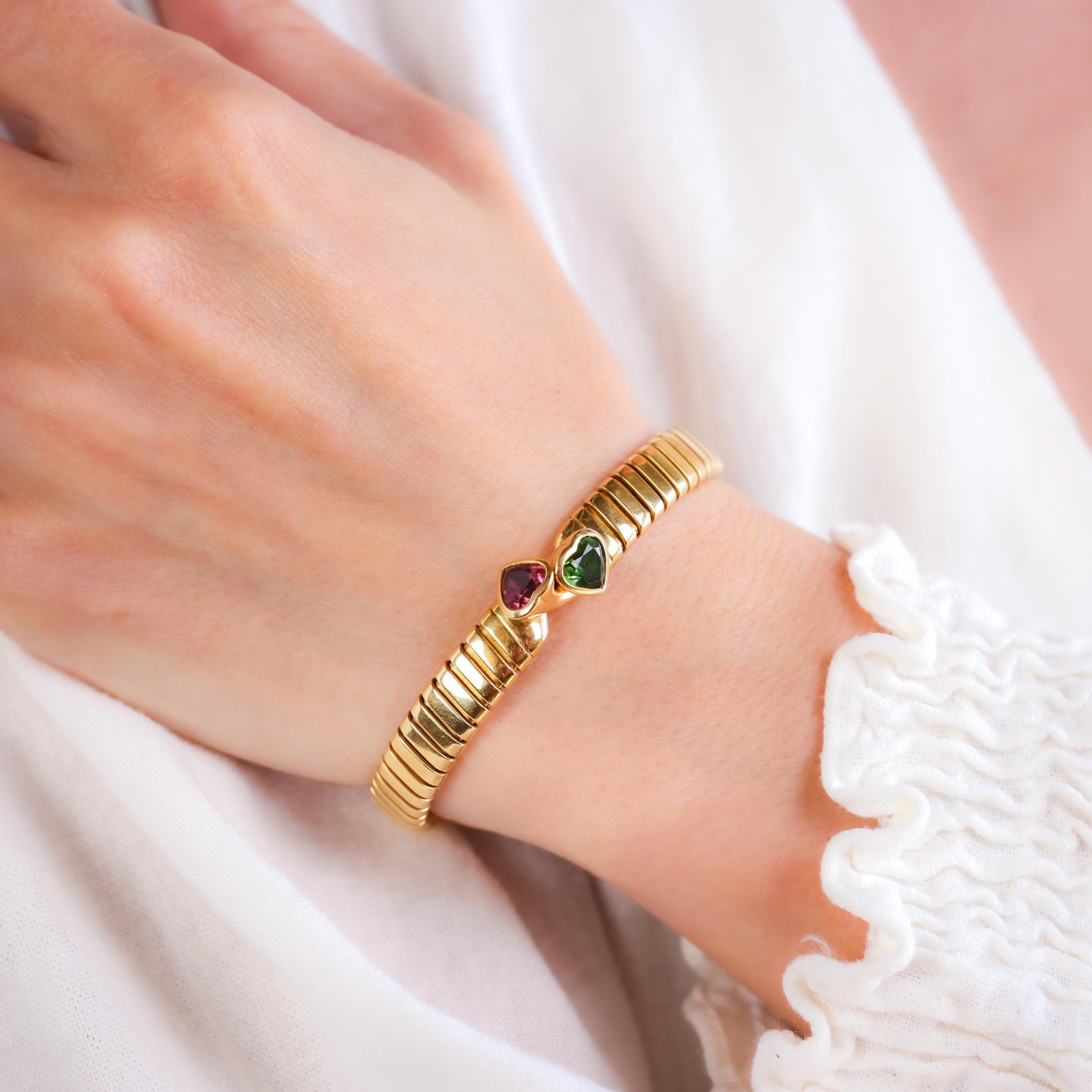 Brand: Bvlgari
Center Stone: Peridot
Cut: Heart
Weight: Approximately 0.8 Carats
Color: Green
Accent Stone: Tourmaline
Cut: Heart
Weight: Approximately 0.8 Carats
Color: Pink
Metal: 18K Yellow Gold
Era: Retro
Circa: 1990s
Hallmarks: Signature,