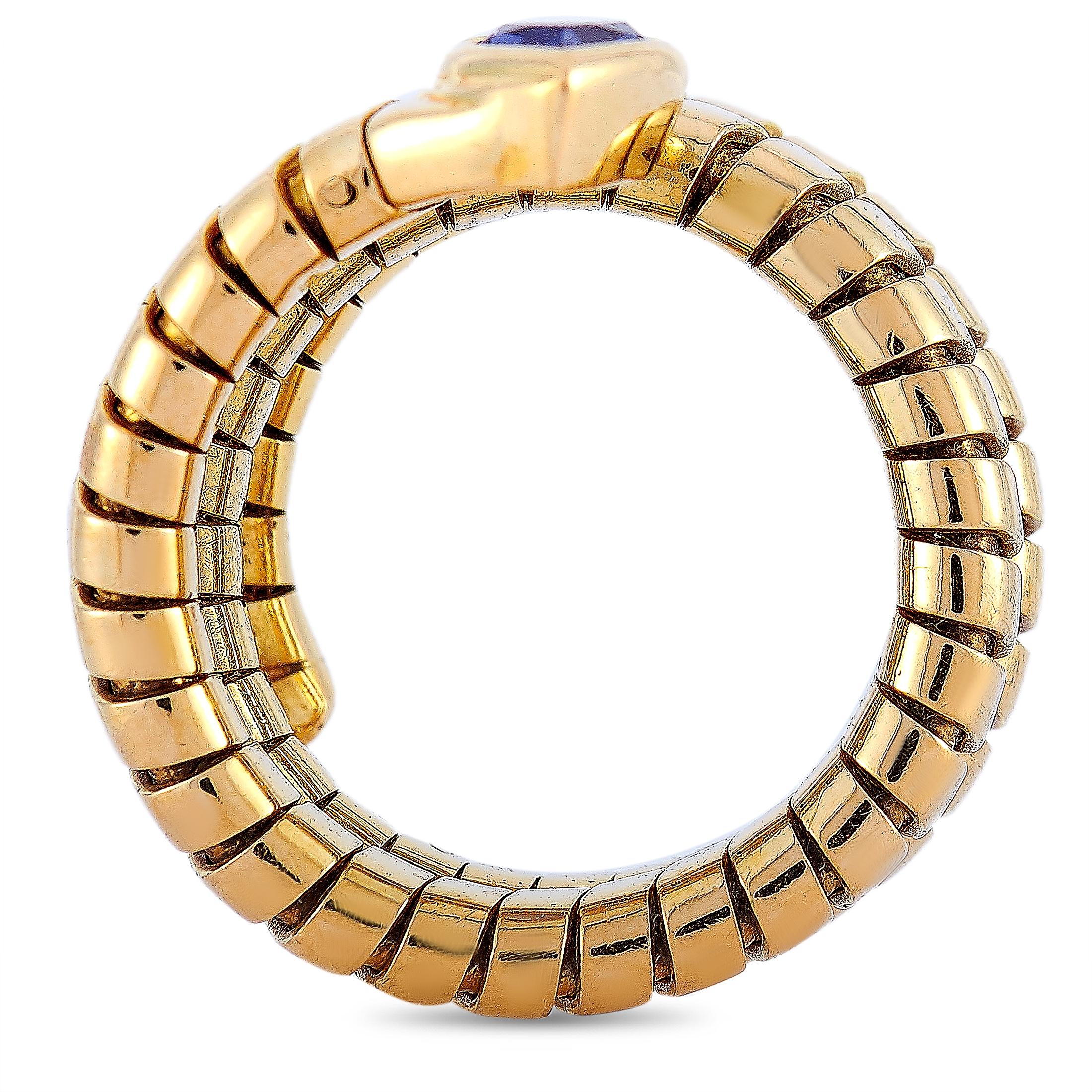 This Bvlgari tubogas ring is made of 18K yellow gold and embellished with an iolite. The ring weighs 15.6 grams and boasts band thickness of 8 mm and top height of 4 mm, while top dimensions measure 7 by 8 mm.
 
 Offered in estate condition, this