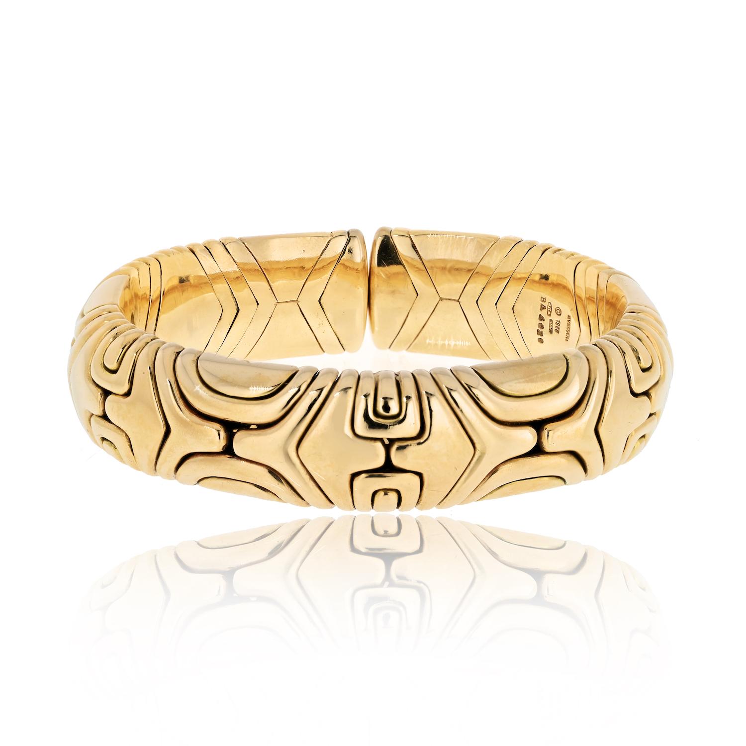 Embrace the timeless elegance of the Vintage 1980's Bvlgari cuff bracelet from the Parenthesis Collection, a true marvel in solid 18K gold. 

Delicately designed with meticulous craftsmanship, this exquisite piece weighs approximately 123 grams,