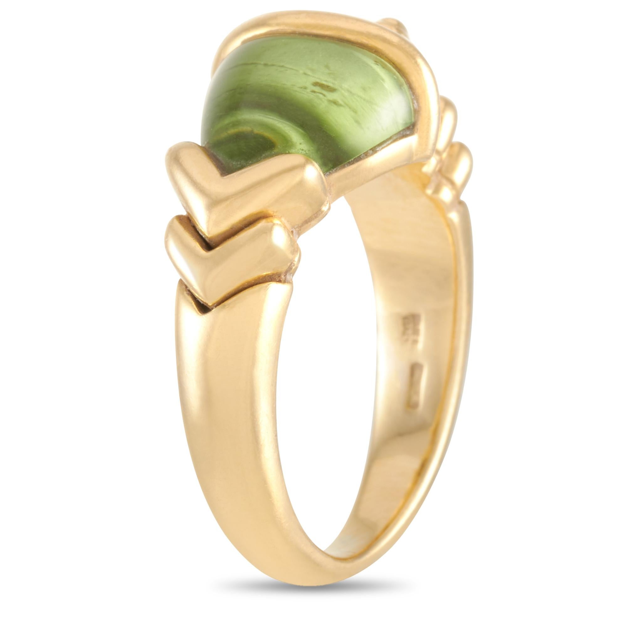 This Bvlgari ring is crafted from 18K yellow gold and set with a peridot. The ring weighs 7.7 grams and boasts band thickness of 4 mm and top height of 7 mm, while top dimensions measure 10 by 20 mm.

Offered in estate condition, this item includes