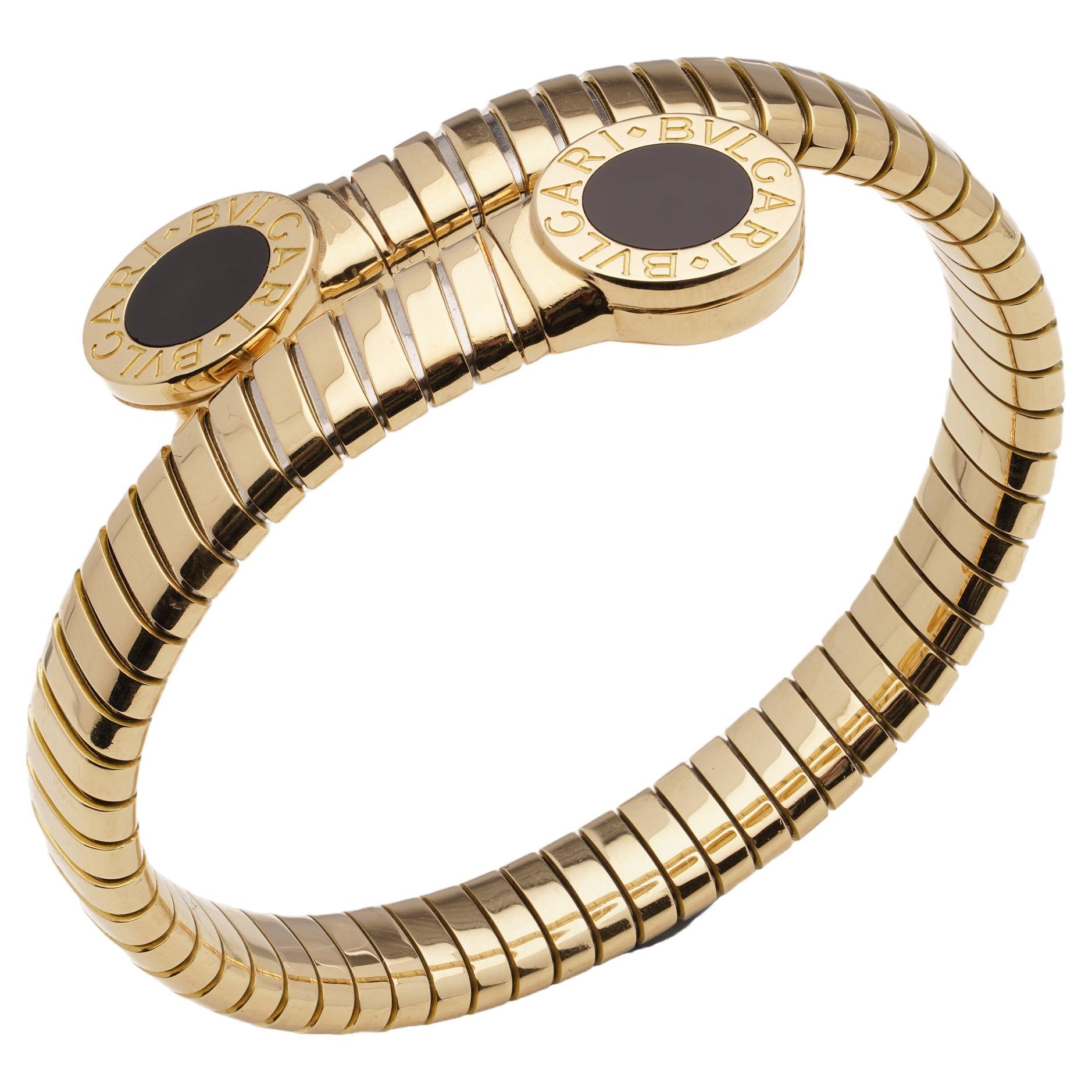 Bvlgari 18kt. gold Tubogas cuff bangle with onyx accents and Bvlgari motif For Sale