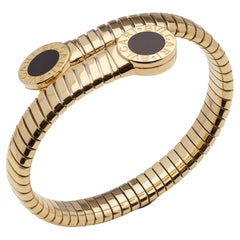 Retro Bvlgari 18kt. gold Tubogas cuff bangle with onyx accents and Bvlgari motif