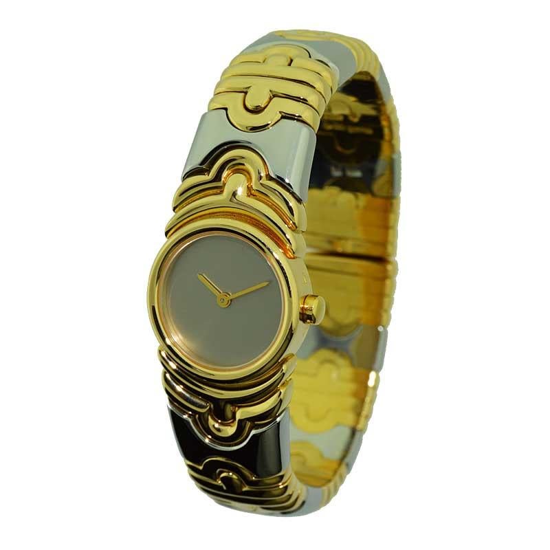 FACTORY / HOUSE: Bvlgari Italy
STYLE / REFERENCE: Ladies Bangle Bracelet / Ref. BJ01
METAL / MATERIAL: 18Kt. and Stainless Steel 
CIRCA: 2010
DIMENSIONS: 20mm Diameter 
MOVEMENT / CALIBER: Swiss Quartz  
DIAL / HANDS: Original Silvered / Baton