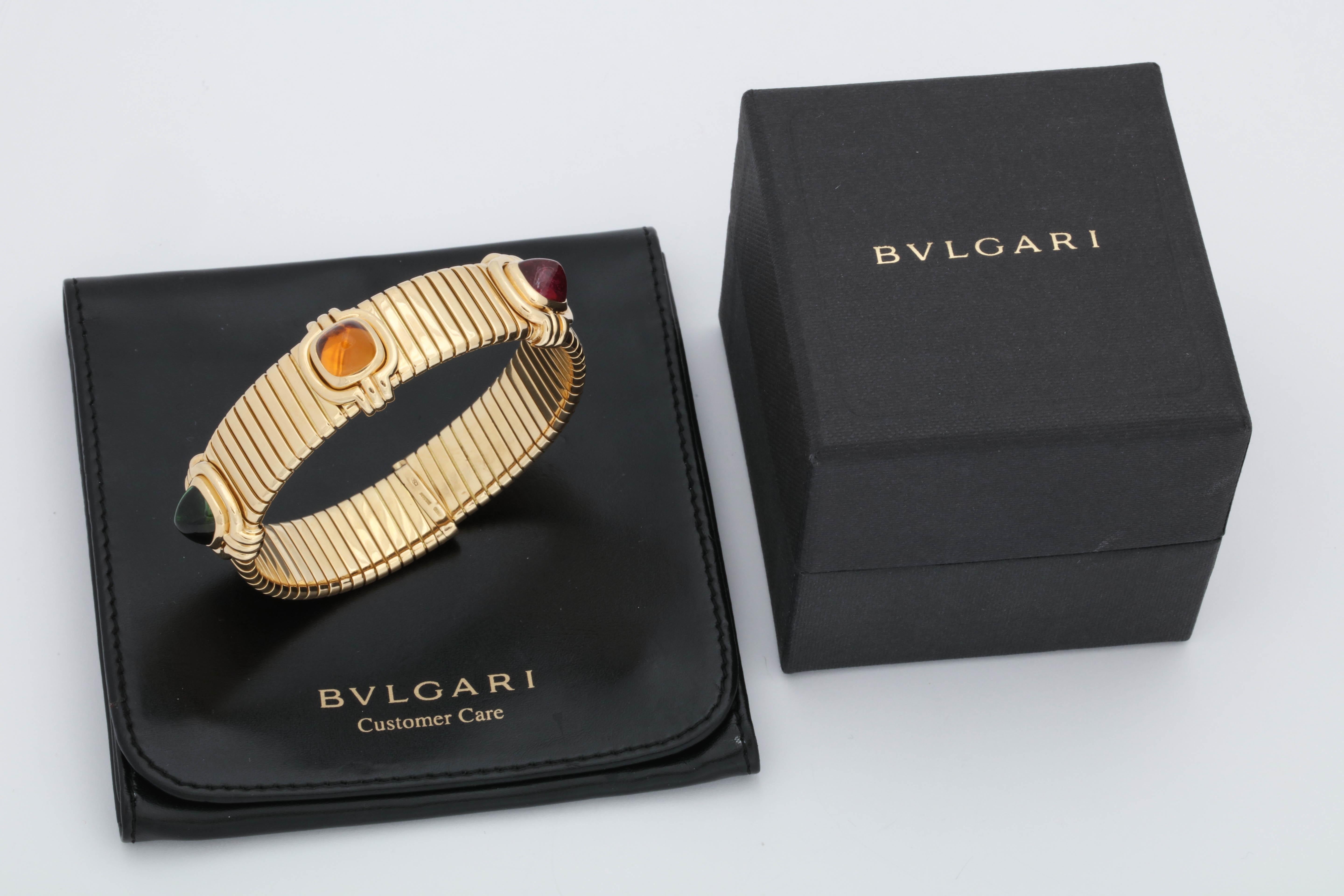 One Tubogas Bracelet Composed Of 18kt Yellow Gold Centering Three Semi Precious Custom Cut Sugarloaf Stones.One Rubelite,One Green Tourmaline And With One Citrine Measuring Approximately 7.5 MM Each Stone.Designed By Bulgari In The 1980's.NOTE:Fits