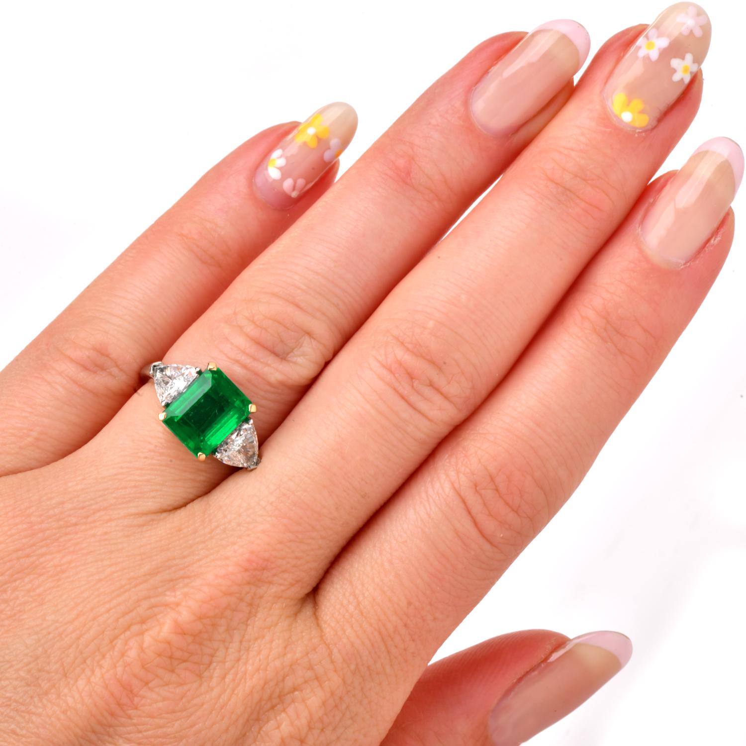 This Classic BLGARI Natural Emerald and Diamond Three Stone Engagement Ring boasts beauty with an approximate total weight of 5.5 grams. 
Expertly crafted in solid Platinum and 18k yellow gold, Featuring a very fine emerald cut Colombian emerald