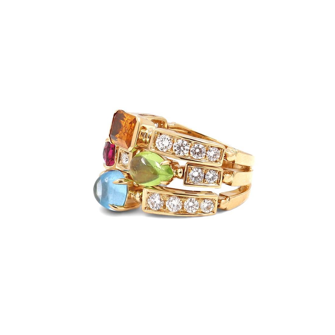 Authentic Bvlgari Allegra ring crafted in 18 karat yellow gold. The ring consists of three adjacent bands adorned with emerald cut citrine, oval-faceted pink tourmaline, pear shape peridot cabochon and cabochon blue topaz. The ring is complemented