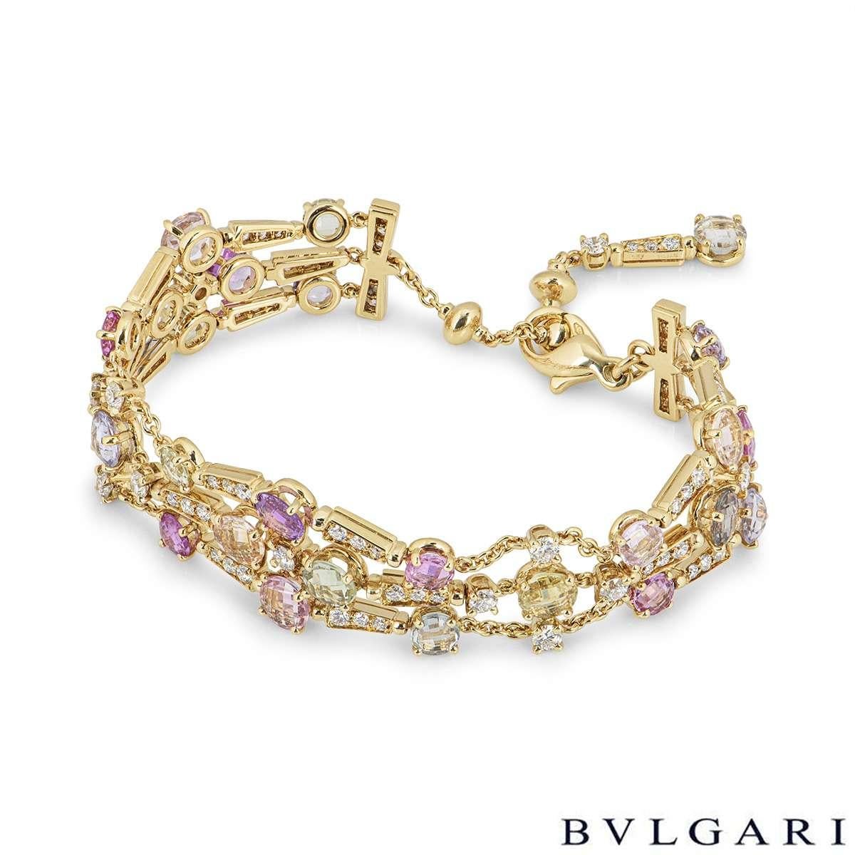 A beautiful 18k yellow gold bracelet from the Allegra collection by Bvlgari. The bracelet features 3 rows, each alternating with single claw set diamonds, diamond set links and and array of different coloured sapphires. There are 27 faceted