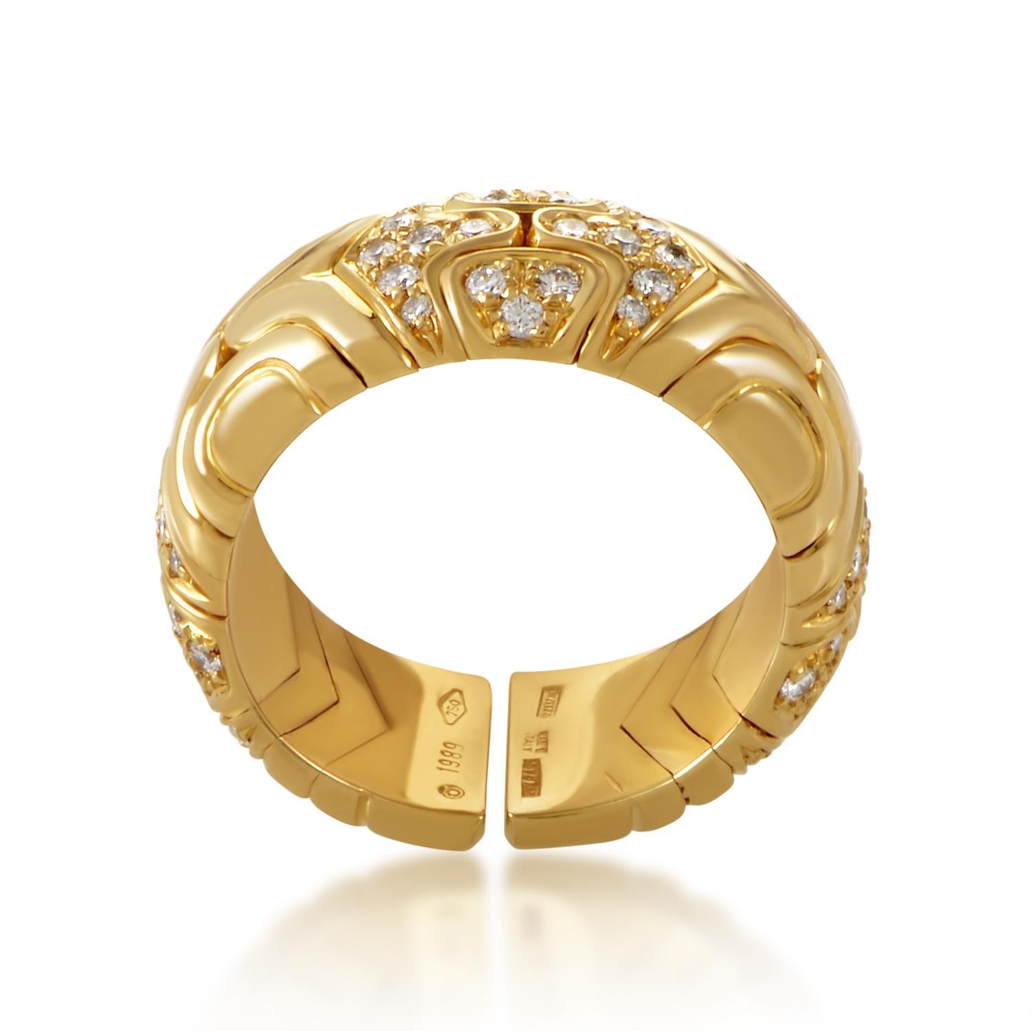 Bearing the intriguing, quintessential Bvlgari pattern upon its gleaming surface, the elegant 18K yellow gold body of this outstanding ring is also graced with glittering diamonds for that special touch of glaring glamour.