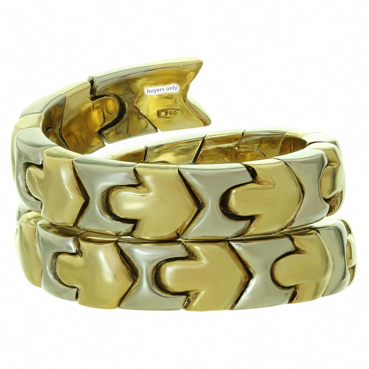 This gorgeous Bvlgari ring from the Alveare collection features a coiled design composed of geometric links crafted in 18k white and yellow gold. This ring has a slightly adjustable size. Made in Italy circa 1990s. Measurements: 0.59