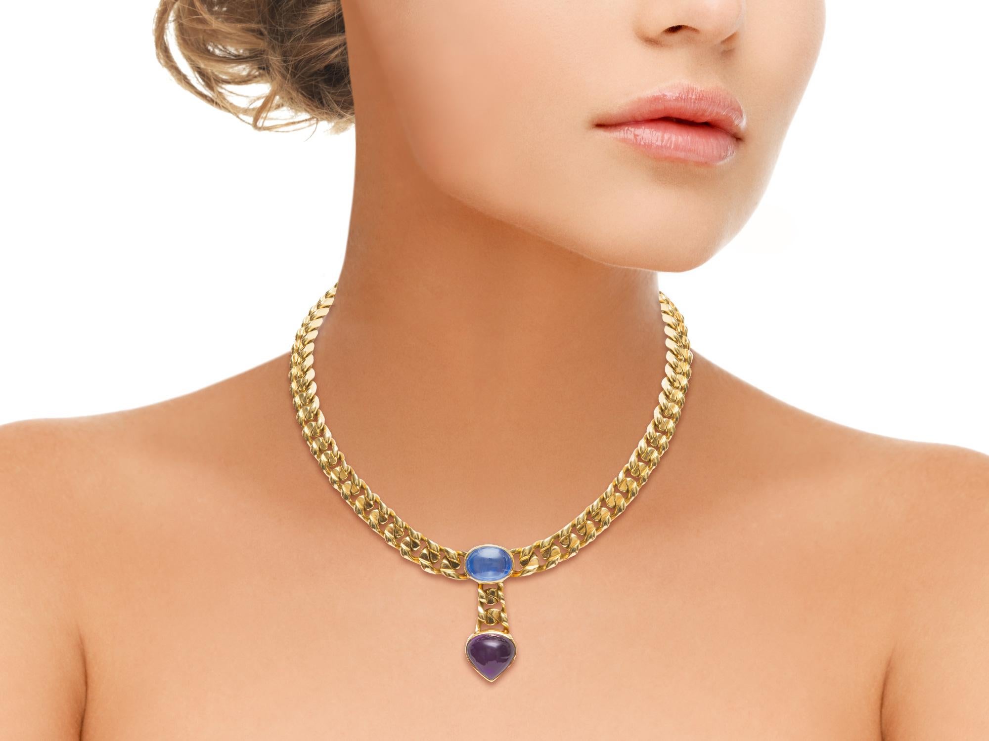 Bvgari 18k yellow gold necklace with a cabochon amethyst and blue tourmaline set in a curb link chain. 