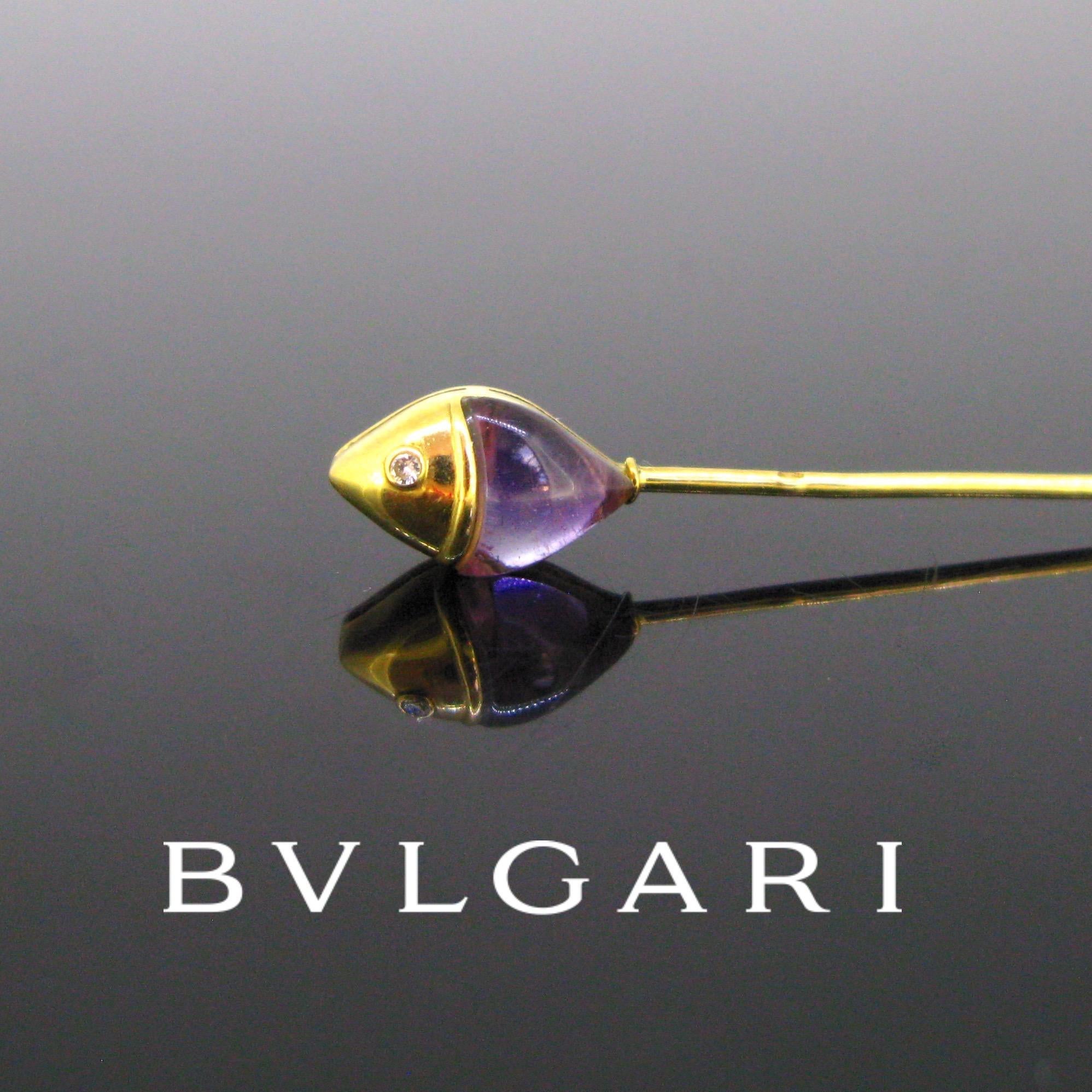 Weight:	2.91gr


Metal:		18kt yellow gold


Stones:	1 Cabochon Amethyst
	1 Round Cut Diamond
	

Condition:	Very Good


Hallmarks:	French, eagle’s head


Signature:	BVLGARI
	

Comments: 		This beautiful stickpin is signed BVLGARI. It features a fish