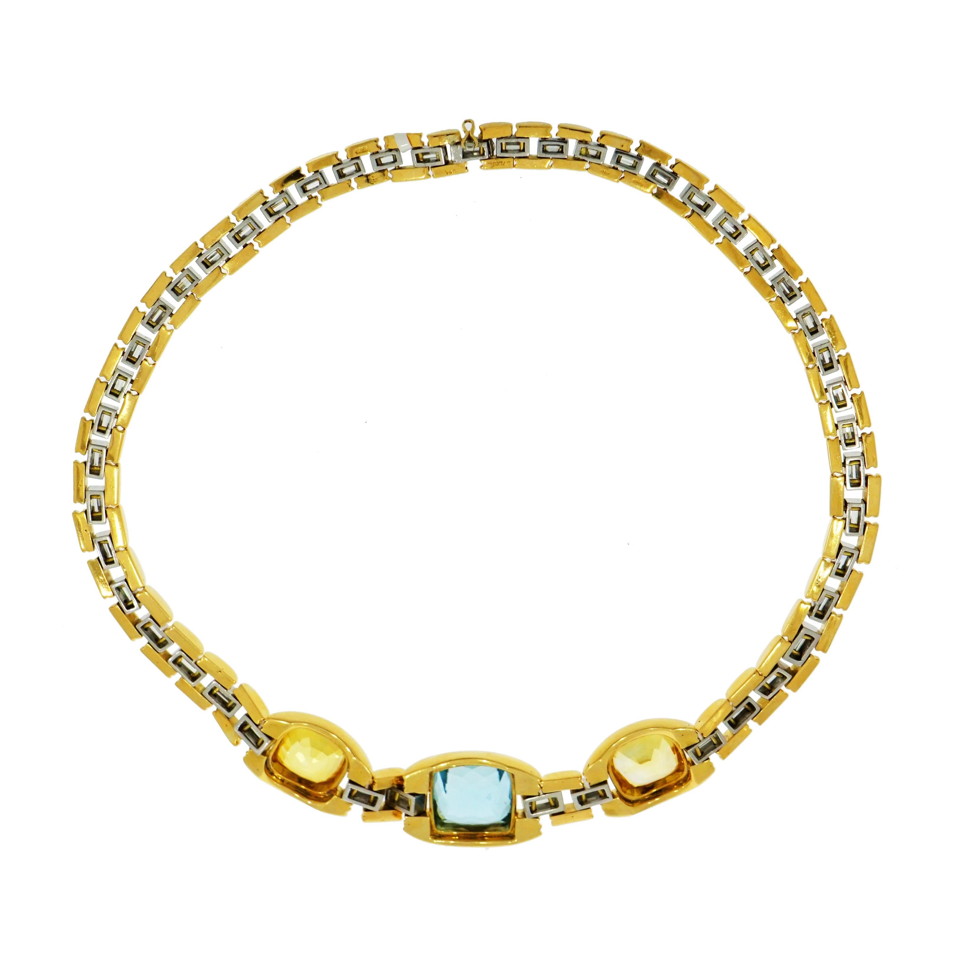 This very unique Estate Bvlgari Necklace crafted in 18k yellow gold features a Certified 12 carat Cushion shaped Aquamarine center with a cushion shaped Unheated Yellow Sapphire at each side. 
The necklace is comprised of 46 Baguette Diamonds. Each