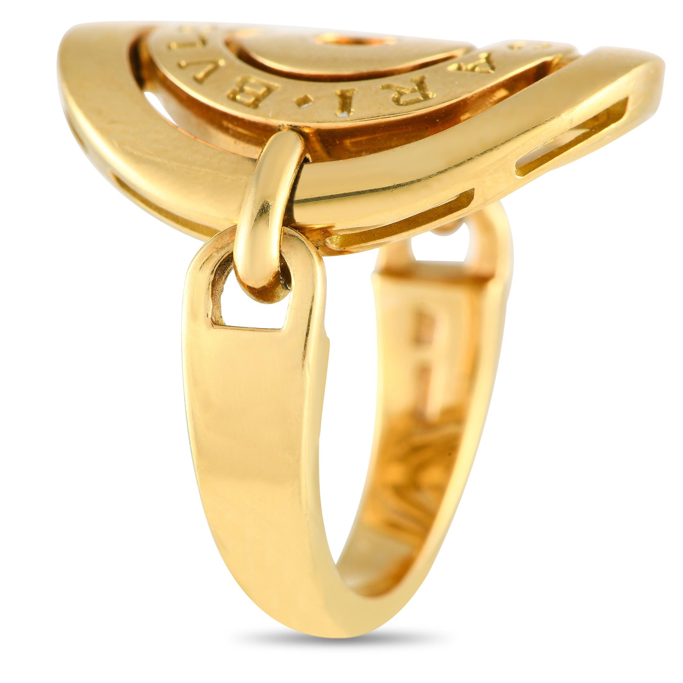 Add interest to your wardrobe with this unusual yet elegant ring. It is from Bvlgari's Astrale collection and is fully crafted in 18K yellow gold. The ring has a 3mm-thick band with swiveling shoulders that hold an openwork centerpiece made of three