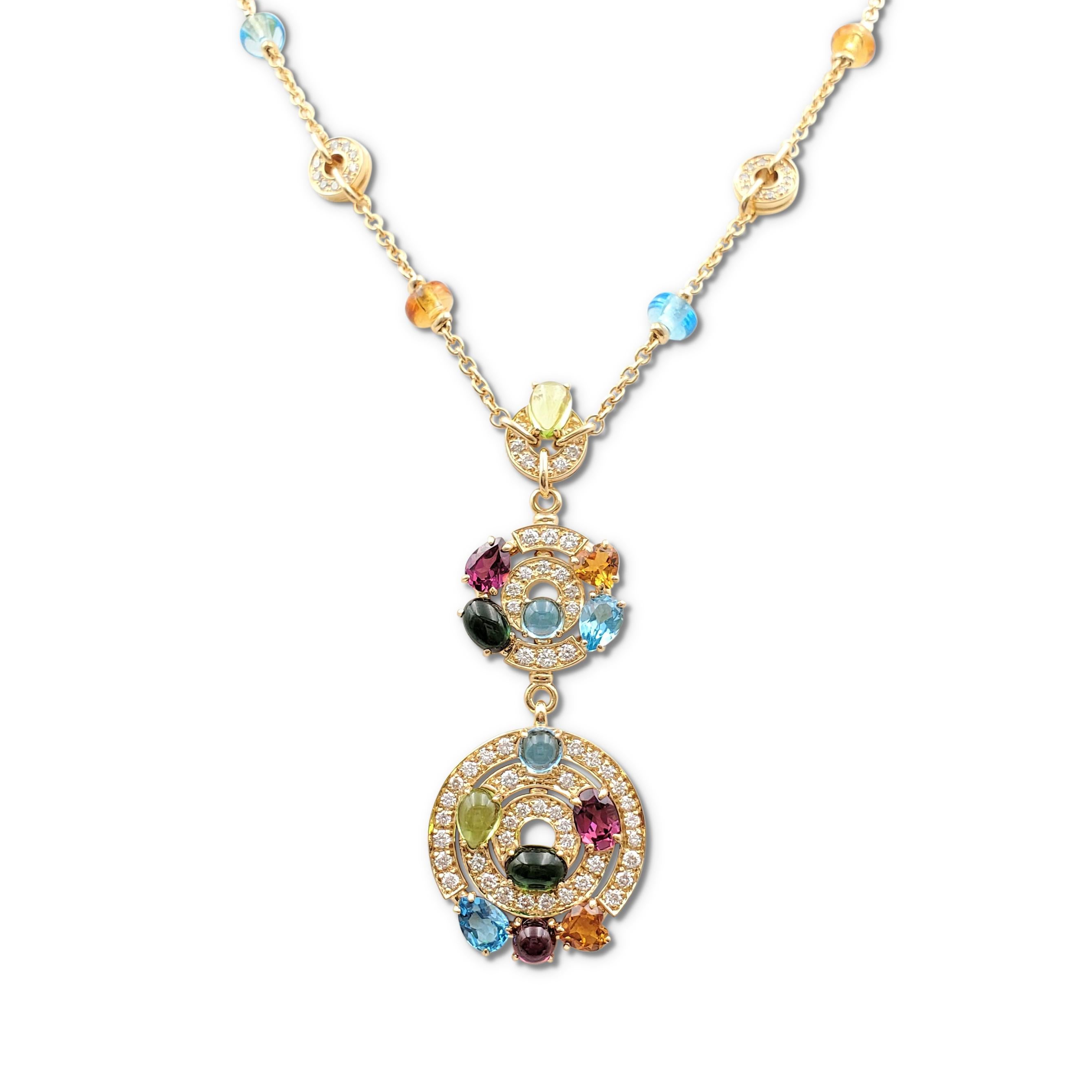 Authentic Bvlgari necklace from the 'Astrale' collection crafted in 18 karat yellow gold and comprised of three graduating circular pave set diamond and multi-colored gemstone discs. Each disc is composed of faceted and cabochon gemstones, including