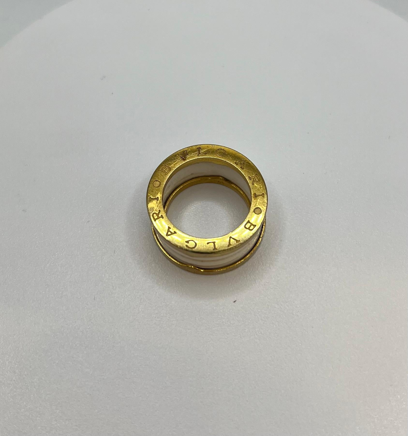 Elevate your style with this exquisite BULGARI Signed Ring crafted from 18-karat yellow gold and featuring a stunning white ceramic accent. With its vintage designer charm, this ring is a timeless piece that adds elegance to any outfit. Size 6.5
