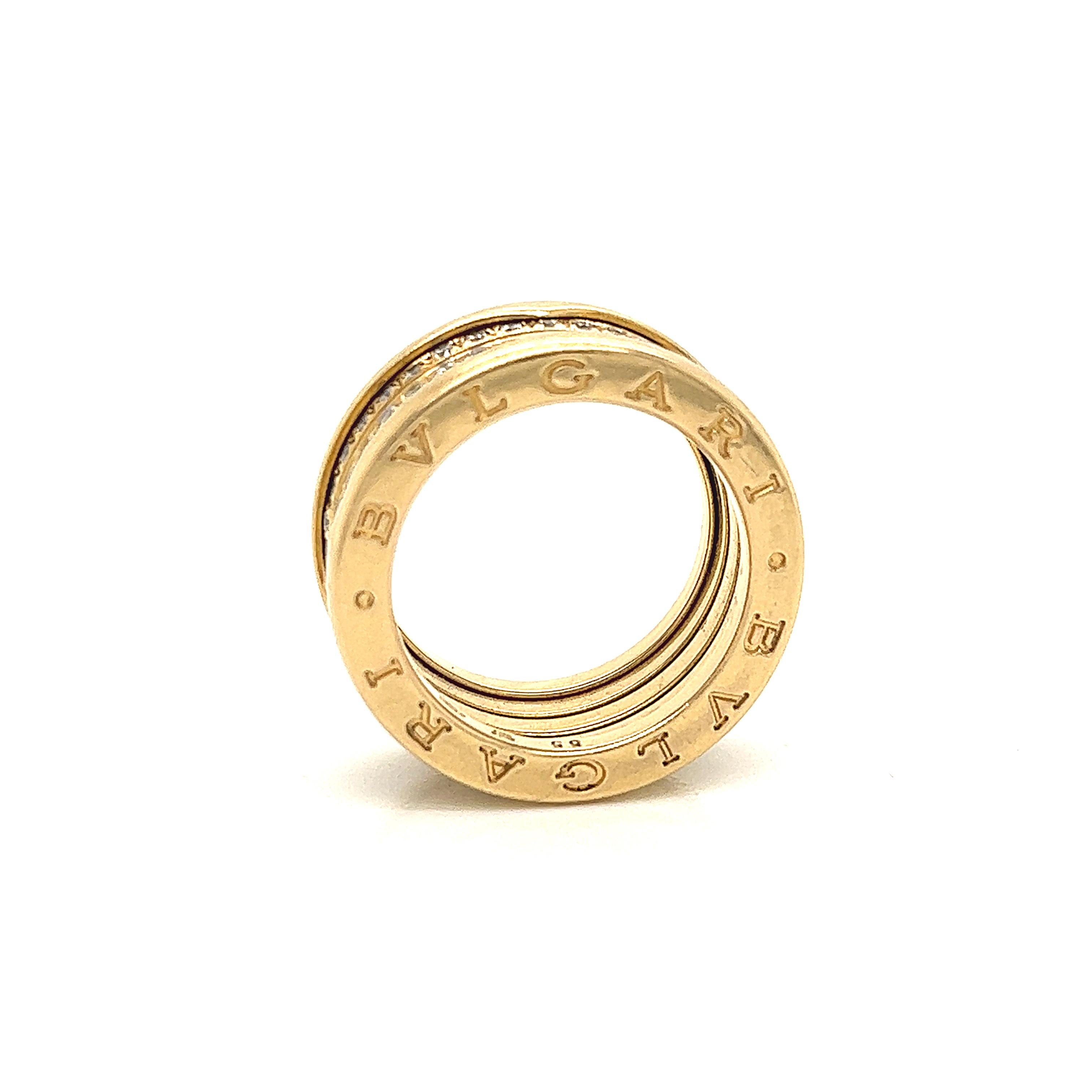Very popular and in demand ring from Bvlgari. The collection is known as the B Zero 1. This ring is crafted in 18k yellow gold and shows a flexible design with three rows of diamonds set in the center.  The diamonds in the design weigh approximately