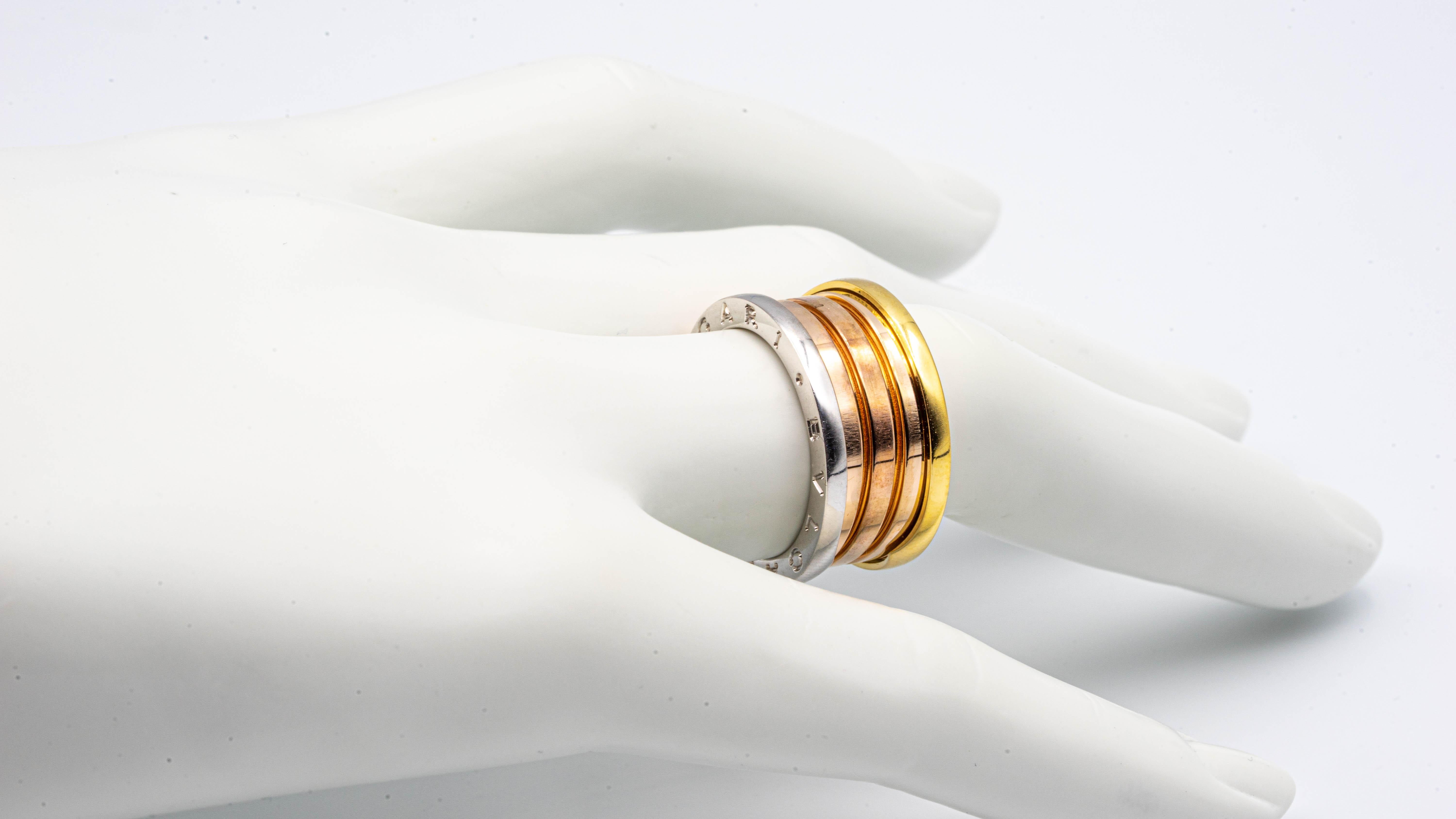 Stylish Bvlgari Ring from the B-Zero Collection finely crafted in 18 karat gold with a combination of 4 bands in white, yellow and rose gold. The ring is stamped 56 Euro size which equals 7.5 US size. Made in Italy
Original Box Included

Stamp: