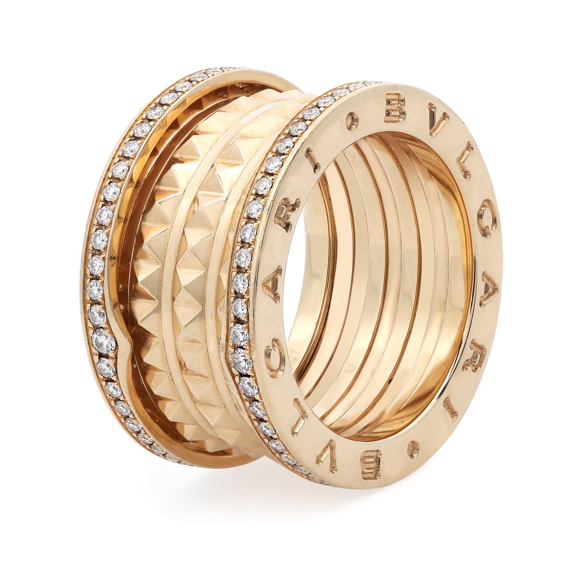 Bvlgari B Zero 1 Rock four band ring. Crafted in 18k yellow gold with studded spiral and pave diamonds on the edges. Ring size: 52 US 6. Runs small because of the thickness and width of the ring. Total diamond weight 0.50 carats. Made in Italy.