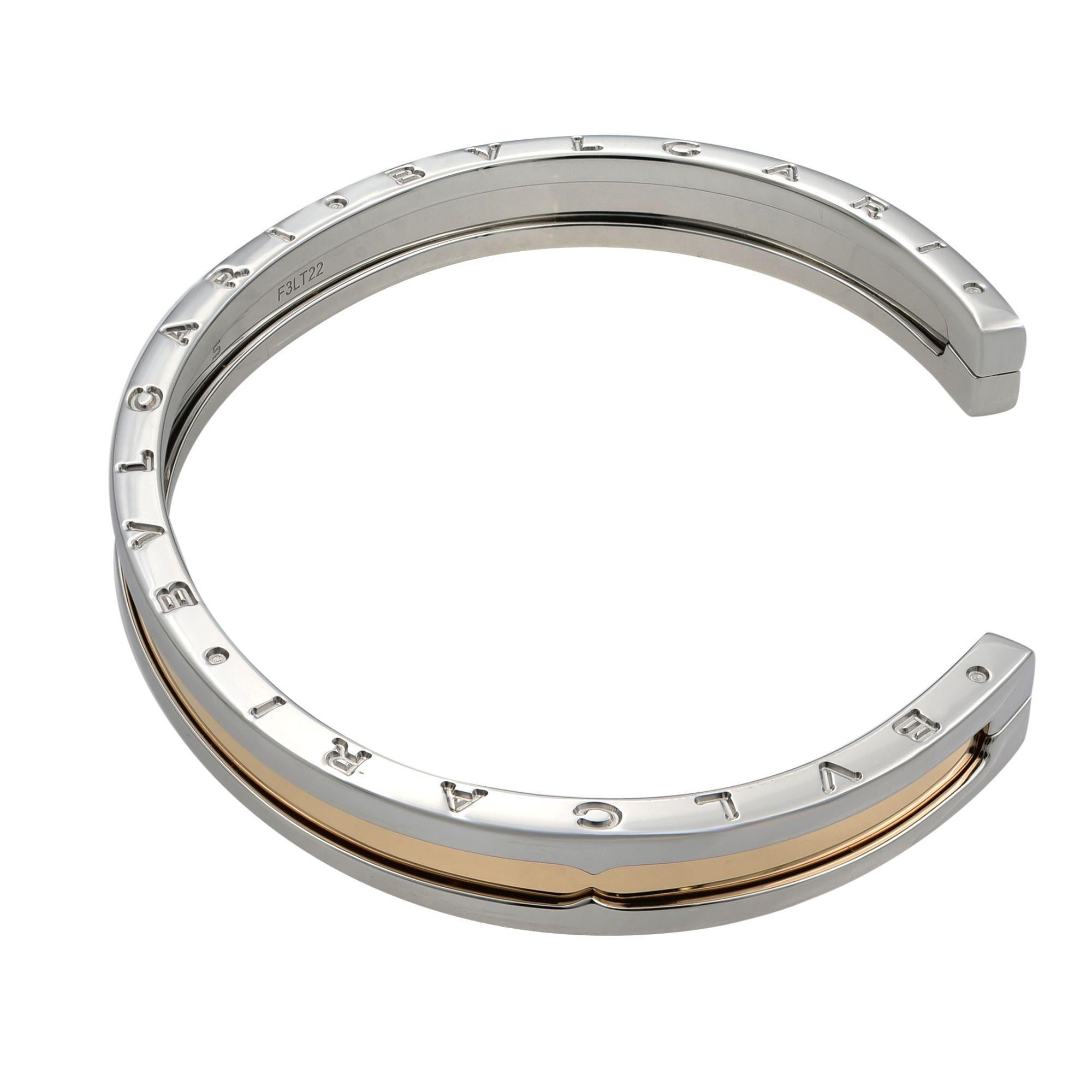 A stainless steel and 18k rose gold cuff bracelet by Bvlgari from the B.zero1 collection. The stainless steel outer edge of the bracelet has Bvlgari Bvlgari engraved on both sides with an 18k rose gold middle section. The bracelet is a cuff design
