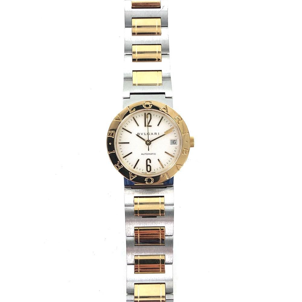 Bvlgari BB 33 SG automatic watch is fashioned in 18 karat yellow gold and stainless steel. The watch features a 32mm case in gold, date, white dial, original two tone deployment bracelet. Circa 2000's.