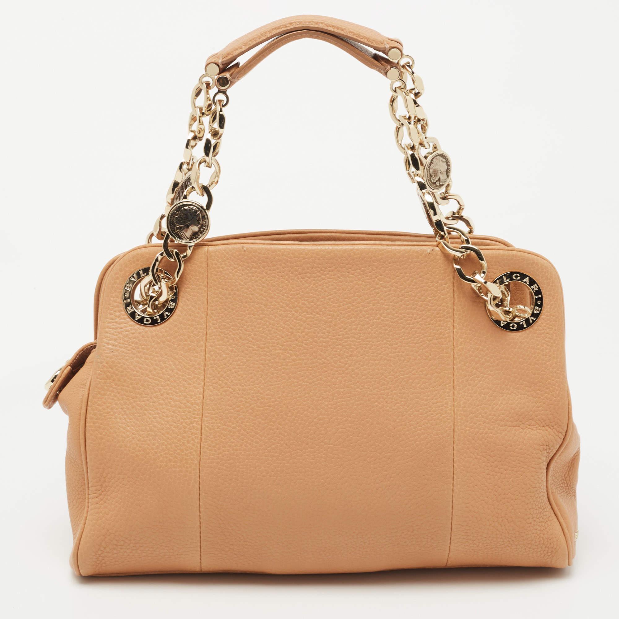 Handbags are more than just instruments to carry one's essentials. They essay our sense of style, and the better the bag, the more confidence we get when we hold it. Crafted from leather, this Bvlgari bag is stylish and functional. It carries a