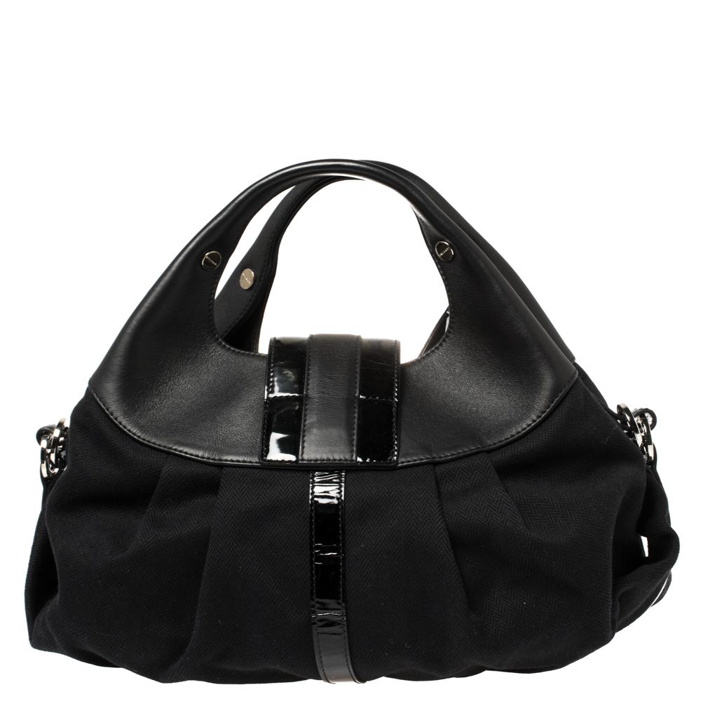 A known style from the house of Bvlgari, Chandra is loved for its comfortable silhouette and elegant appeal. This black one is meticulously crafted from canvas and leather and has the signature slouchy shape with broad pleats, dual top handles, and