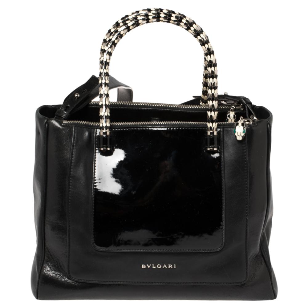 Bvlgari's Serpenti collection has stunning creations and this tote is a fine example. Crafted from patent leather & leather, the Serpenti Scaglie tote is styled with retractable snake handles. The bag comes with a spacious fabric-lined interior and