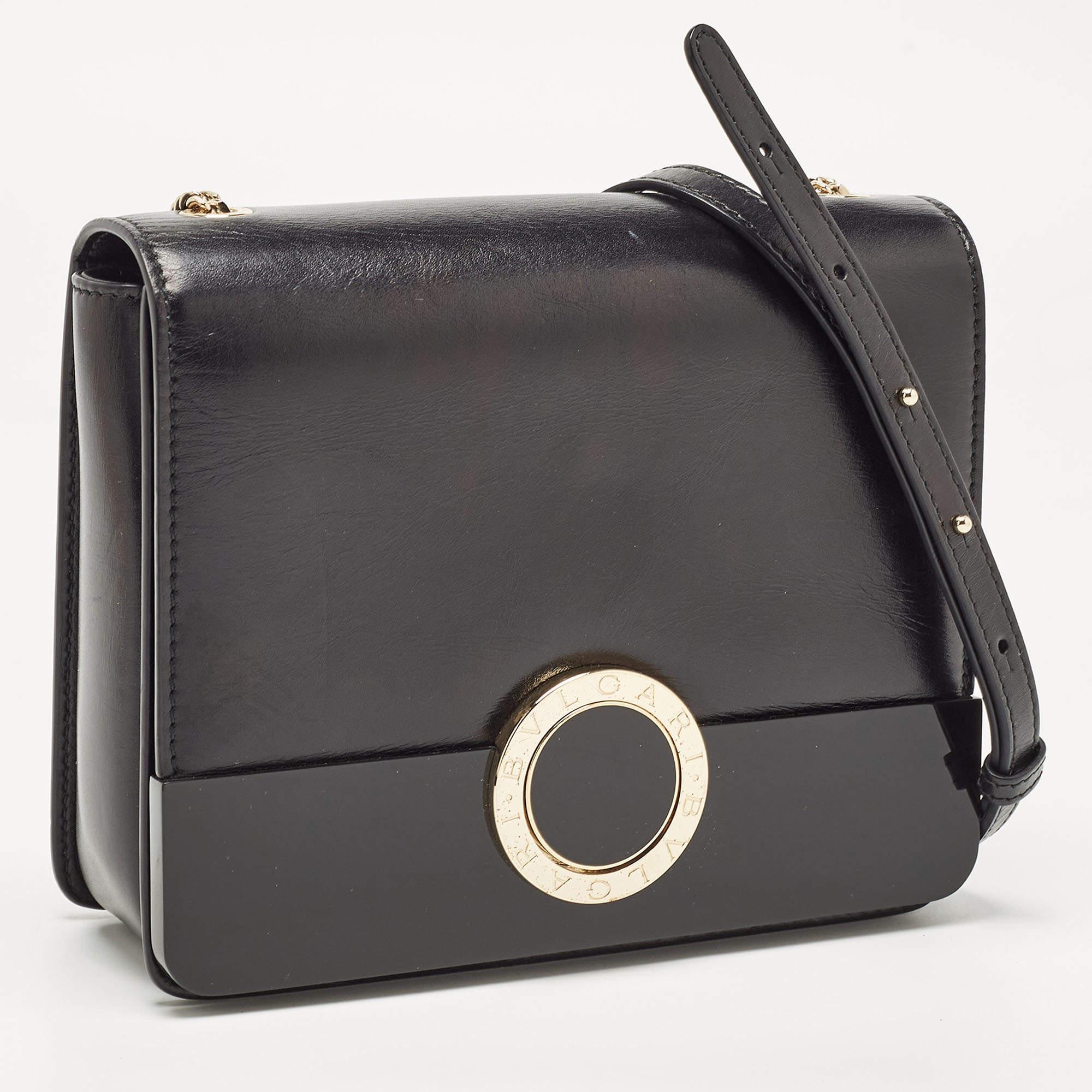 We bring you your best buy of the year in the form of this elegant and charming shoulder bag from the house of Bvlgari. Crafted with precision from leather and perspex, it is covered in shades of black. It has a structured silhouette with a full
