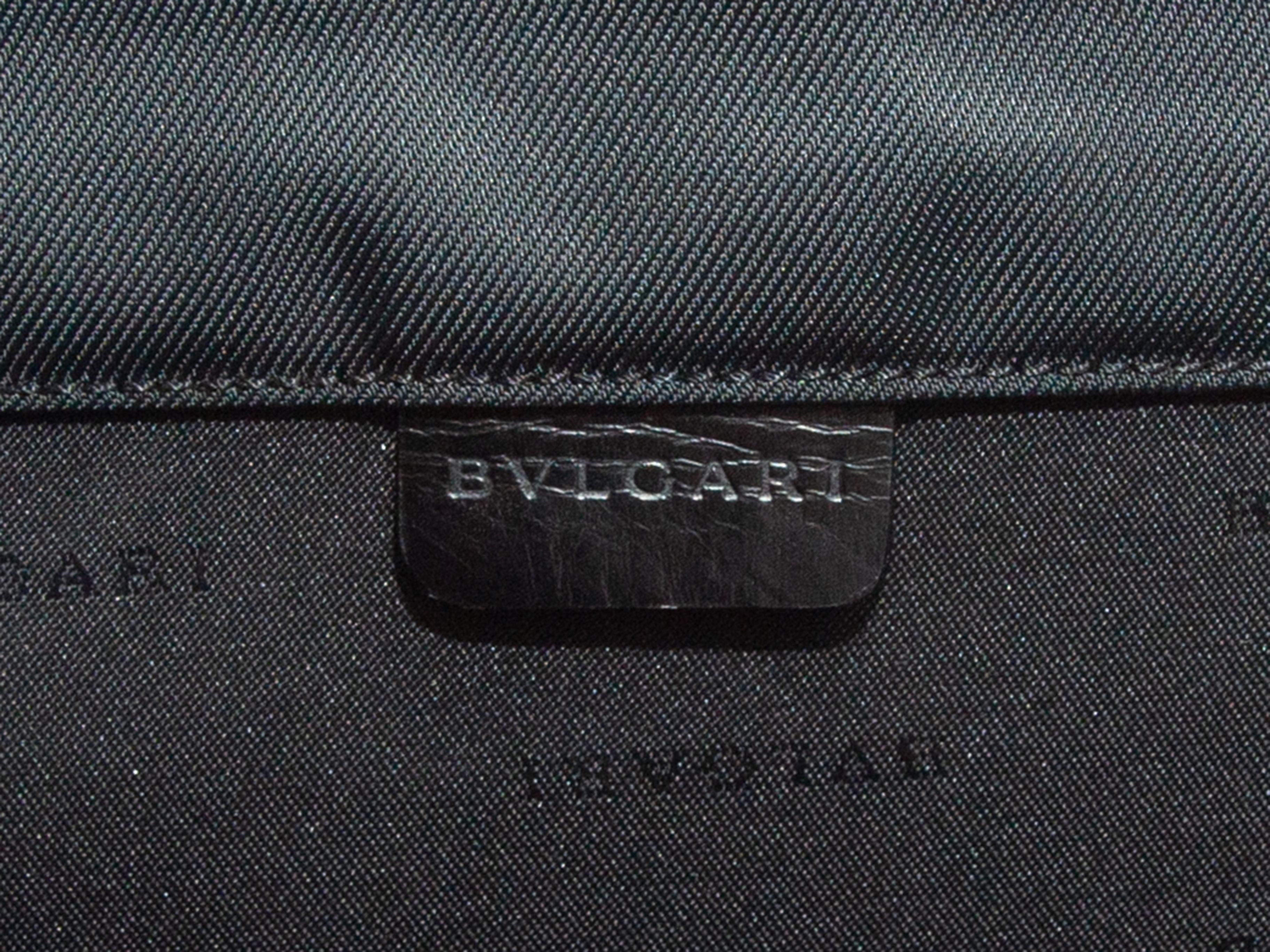 Product details: Black leather and nylon briefcase by Bvlgari. Silver-tone hardware. Single top handle. Dual turn-lock closures at front flap. 14