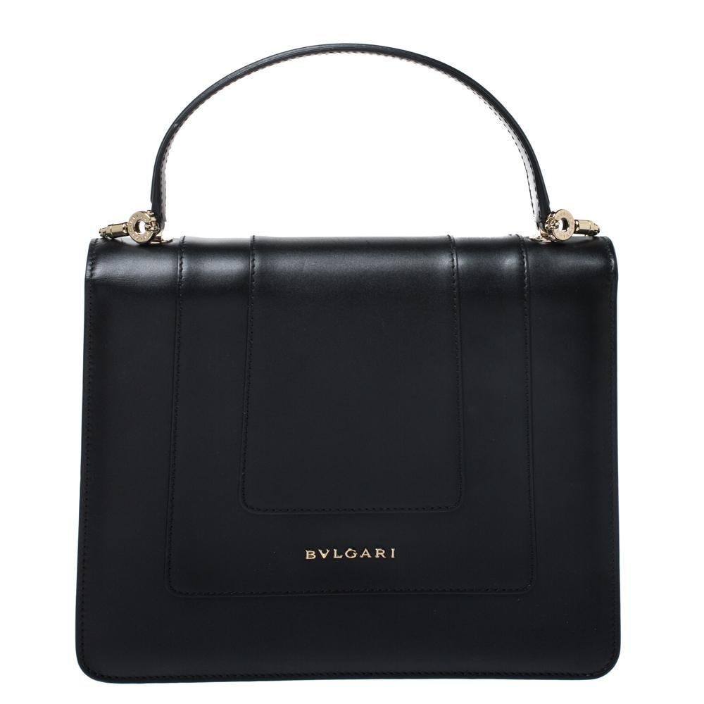 Dazzle the eyes that fall on you when you swing this stunning Bvlgari creation. Crafted from leather in a breathtaking black hue, the shoulder bag is styled with a flap that has the iconic Serpenti head closure. The bag has a spacious fabric