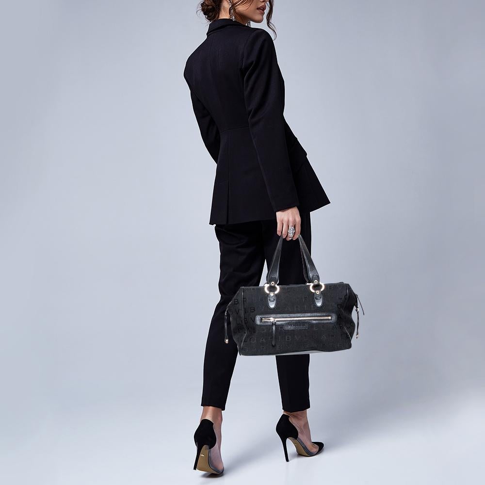 A truly posh and elegant piece to add to your collection. This Boston duffel bag by Bvlgari is crafted from logo-detailed canvas and leather and styled with a front zip pocket. It features a top zip closure, two handles, and a spacious interior to