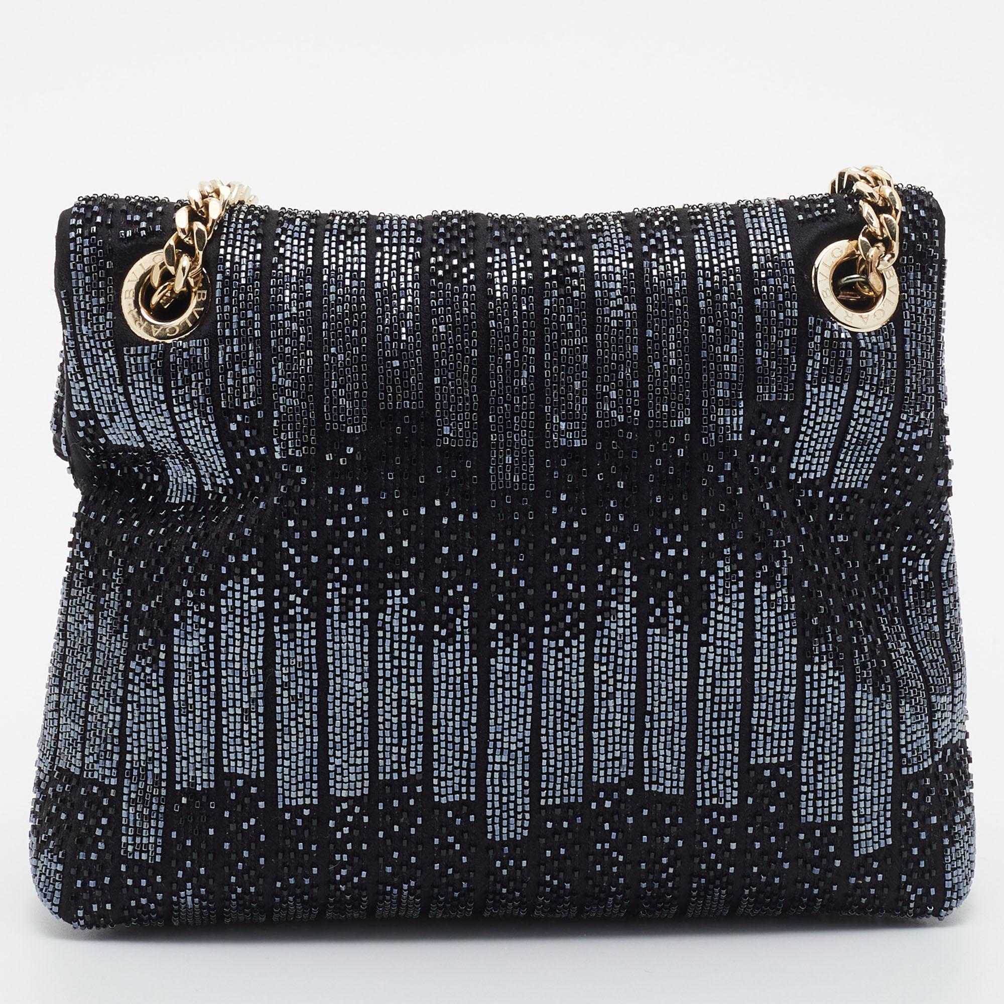 Whether you're leaving home for a lunch date, dinner meeting or simply to run errands, this stylish shoulder bag from Bvlgari promises an elevated look. It is made from satin and bead embellishments and features a gleaming Monette accent on the