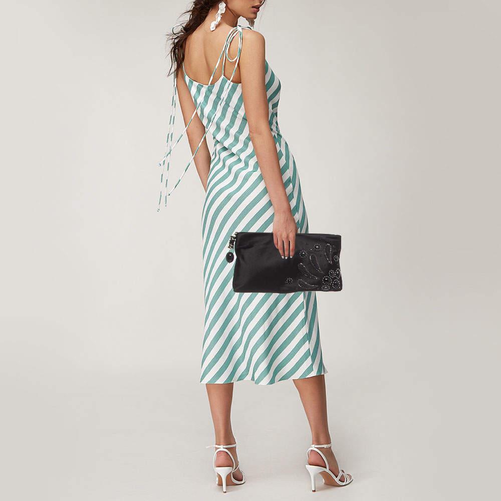 Functional and fashionable, this clutch is a classy styling choice. It is crafted from quality materials, and its lined interior will keep your evening essentials in a neat way. 