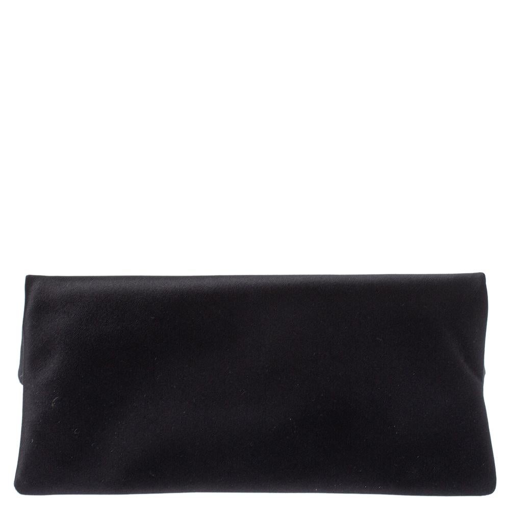 Crafted from satin, this Bvlgari Monete clutch is stylish and functional. It carries a black exterior, gold-tone hardware, and a satin interior. The bag is sized well and detailed with a distinct charm at the front.

