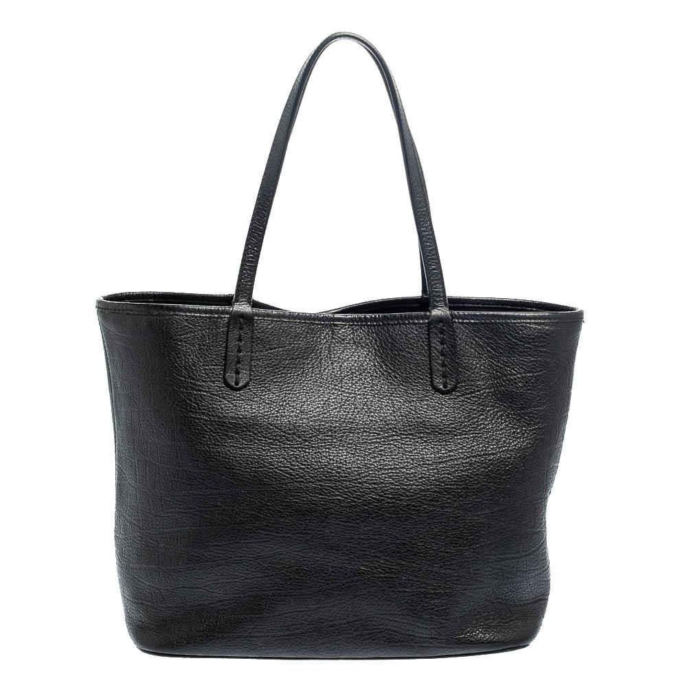 Sophistication and good aesthetics are what the Bvlgari tote has to offer for you. It is made of leather and designed with signature embossing on the front, two top handles, and a spacious silhouette. The tote boats of a canvas-lined interior that