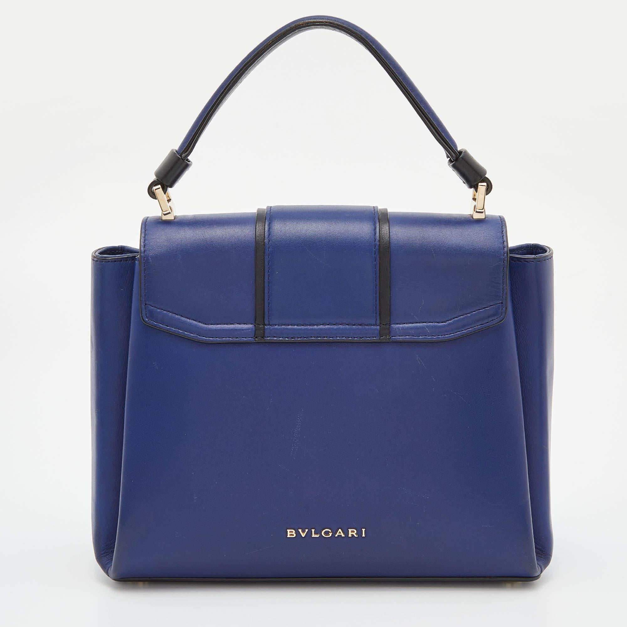 This beauty is from Bvlgari, and it is a sight to behold! It is excellently crafted from leather and designed to make every handbag lover swoon. The bag holds a stunning enamel lock on the flap which has the brand's iconic design. A well-sized