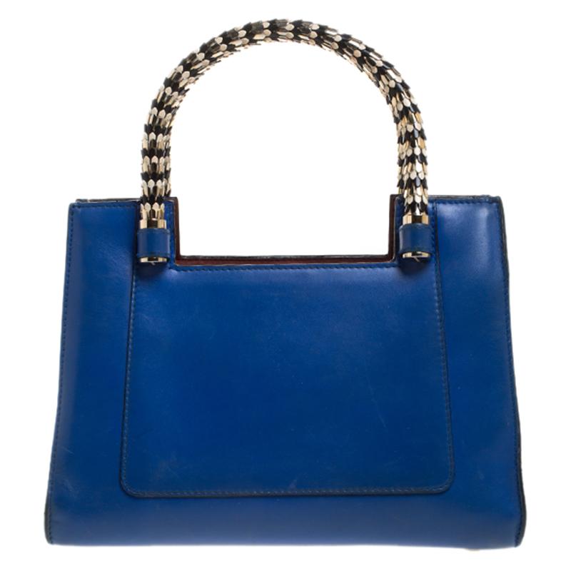 Bvlgari's Serpenti collection has stunning creations and this tote is a fine example. Crafted from blue leather, the Serpenti Scaglie tote is styled with retractable snake handles and burgundy leather panels on the sides. The bag comes with a