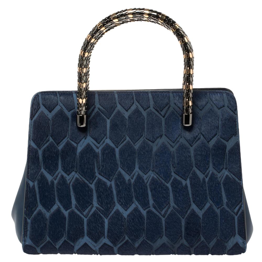 Bvlgari's Serpenti collection has stunning creations and this tote is a fine example. Crafted from blue calf hair, the Serpenti Scaglie tote is styled with retractable snake handles and leather panels on the sides. The bag comes with a spacious