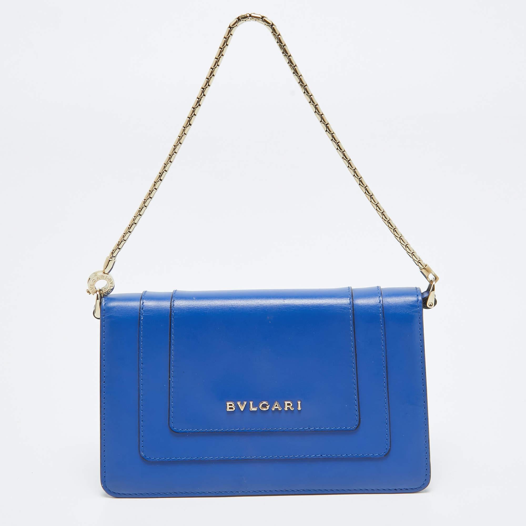 The Bvlgari Serpenti Forever pochette is a captivating blend of luxury and sophistication. Crafted from exquisite blue leather, its compact design exudes elegance. The iconic Serpenti head closure adds a touch of opulence, making it a timeless