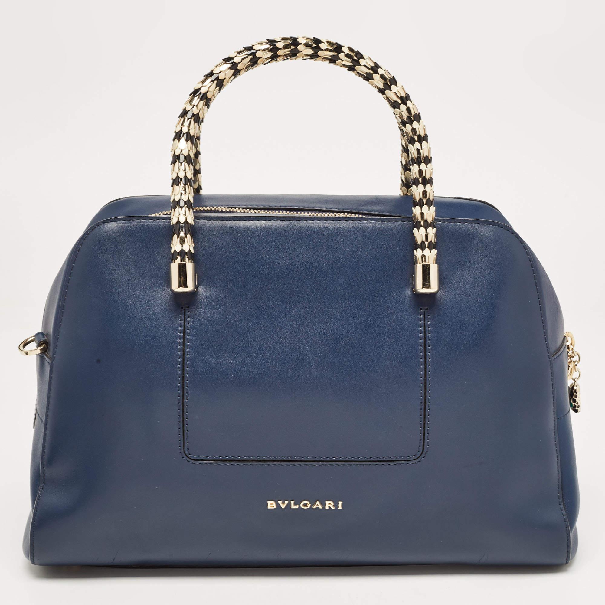 Crafted from leather, the Bvlgari Serpenti Scaglie bag is styled with snake handles and has the iconic Serpenti head on the zip puller. The bag comes with a spacious suede-lined interior and has a removable shoulder strap for an easy carrying