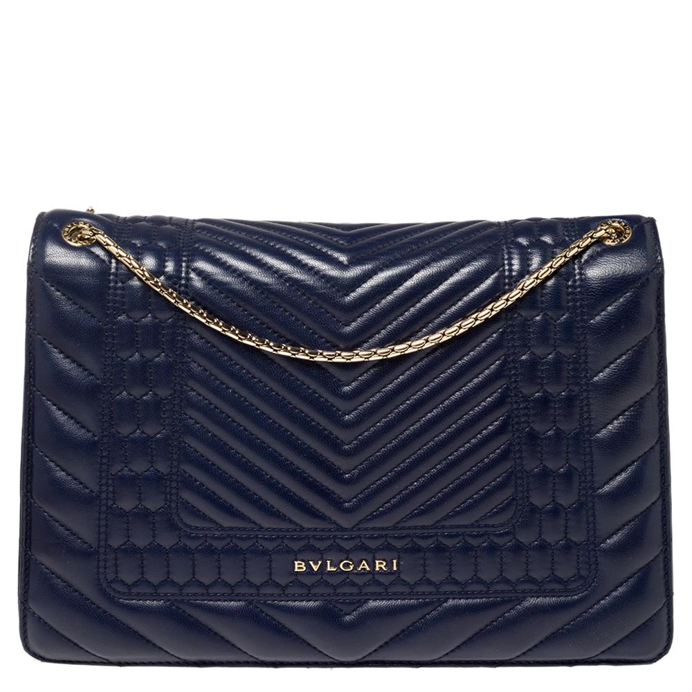 Dazzle the eyes that fall on you when you swing this stunning Bvlgari creation. Crafted from quilted Scaglie leather in a soothing blue hue, the shoulder bag is styled with a flap that has the iconic Serpenti head closure. The bag has a spacious