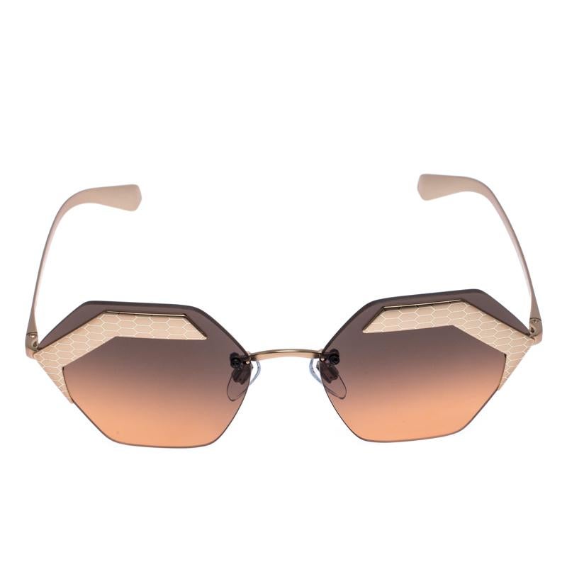 The stylish frames come from the house of Bvlgari and have been sculpted in acetate and metal to form a geometric shape and feature Serpenti accents on the front. They come with black gradient lenses and bronze-tone hardware. They are finished with