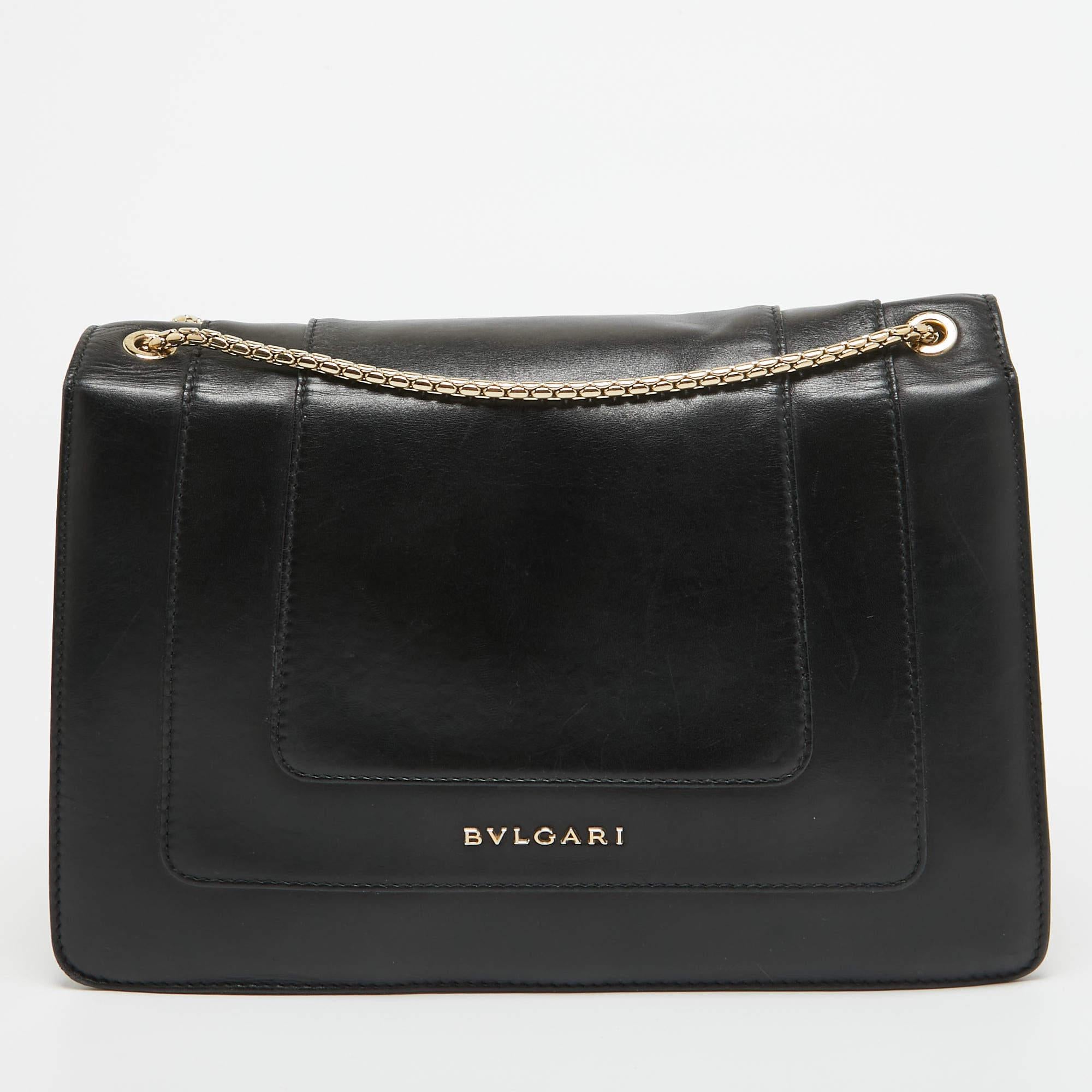 Most designs from Bvlgari with their striking elements, pay tribute to the Roman roots, and this bag is no different. Made from leather, it is an accessory of utility and luxury. Lined with fabric, the interior has enough room to dutifully store