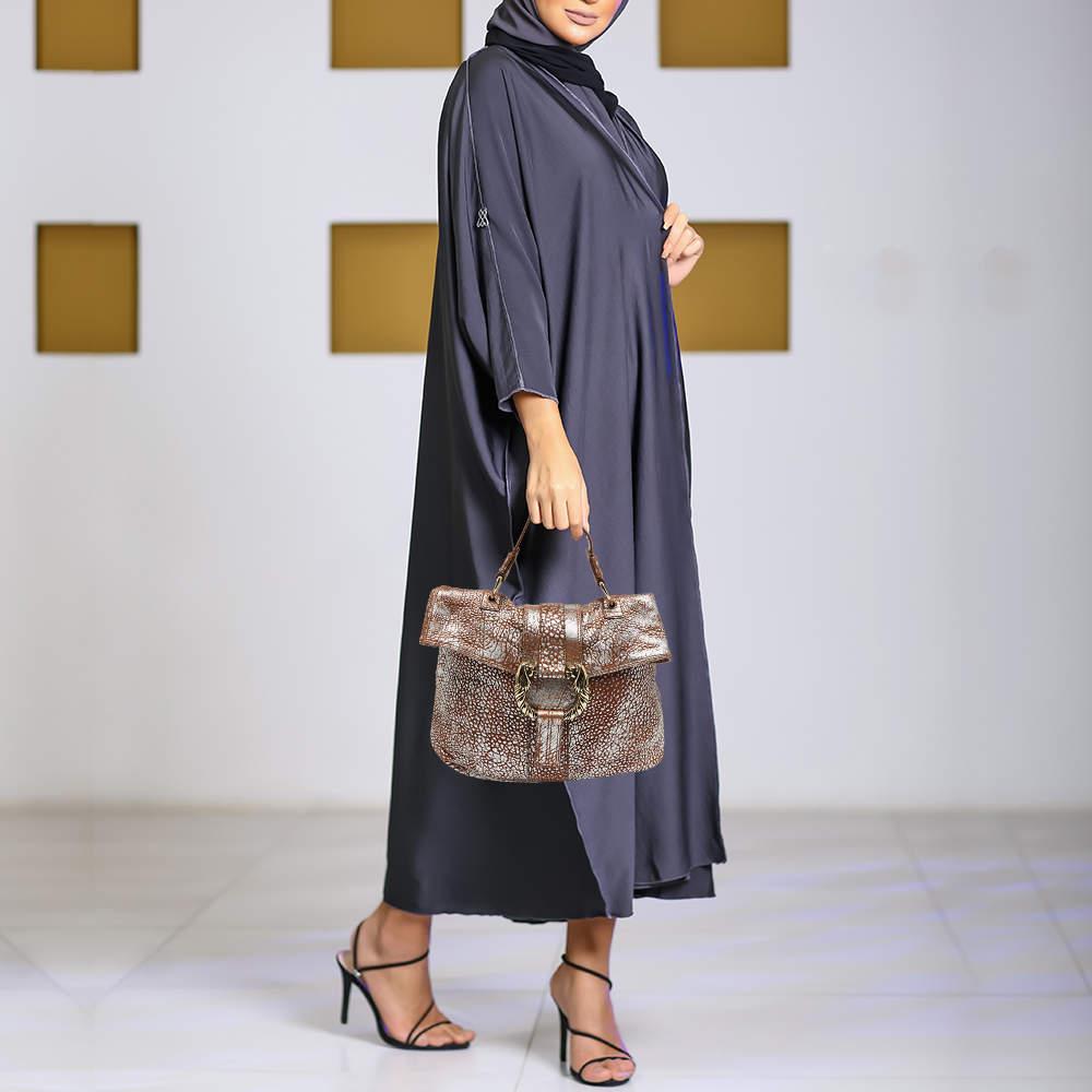 Exuding unparalleled elegance and sophistication this bag is made from the finest material in a gorgeous hue. While the roomy interior offers ample space the top handle allows you to carry it with much elegance.