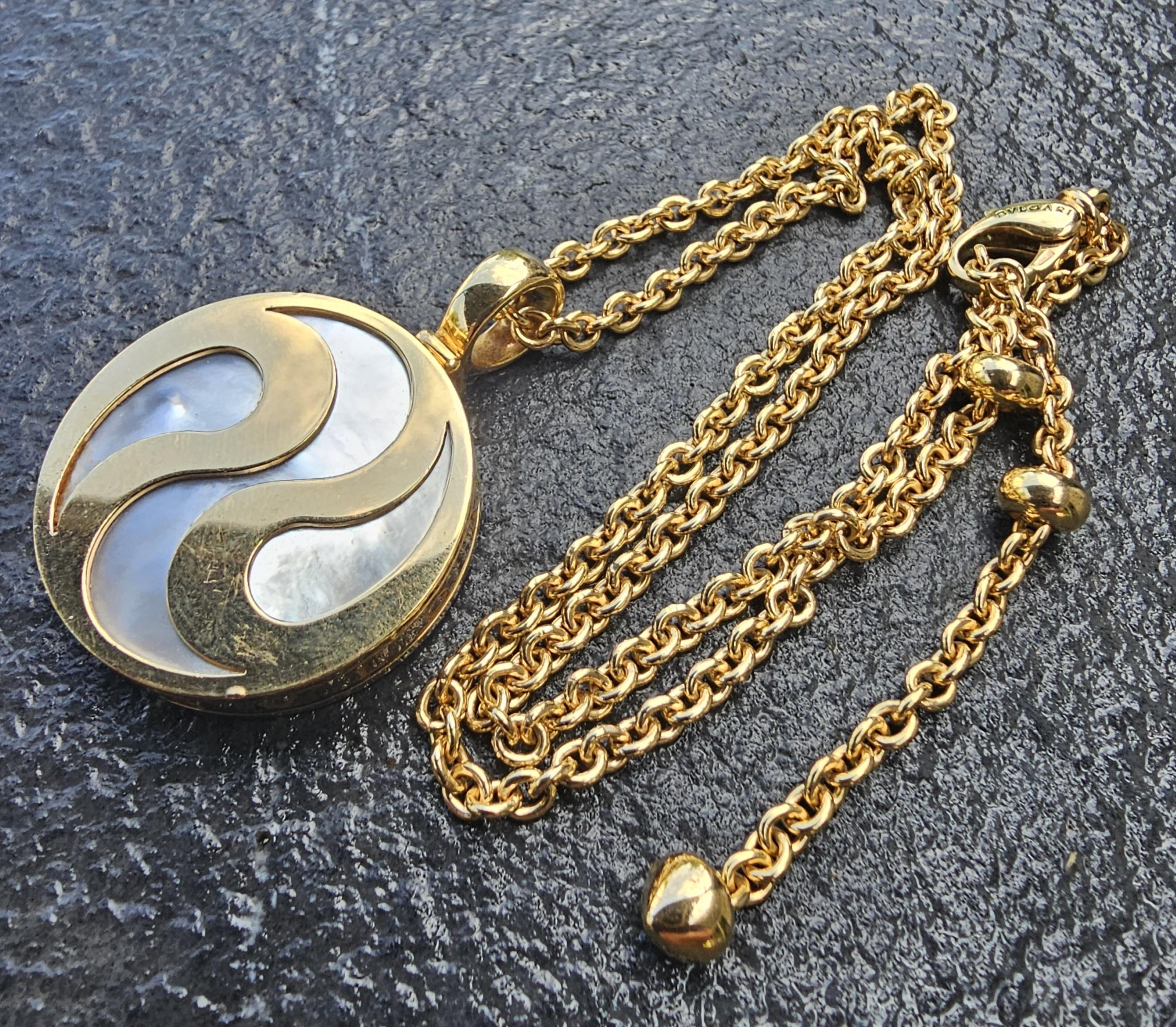 This is a rare all-gold version, even the back plate is solid 18k gold. However, it is still marked as gold and steel, because the ball bearings inside are steel.

This stunning Bvlgari pendant necklace is a must-have for jewelry aficionados.