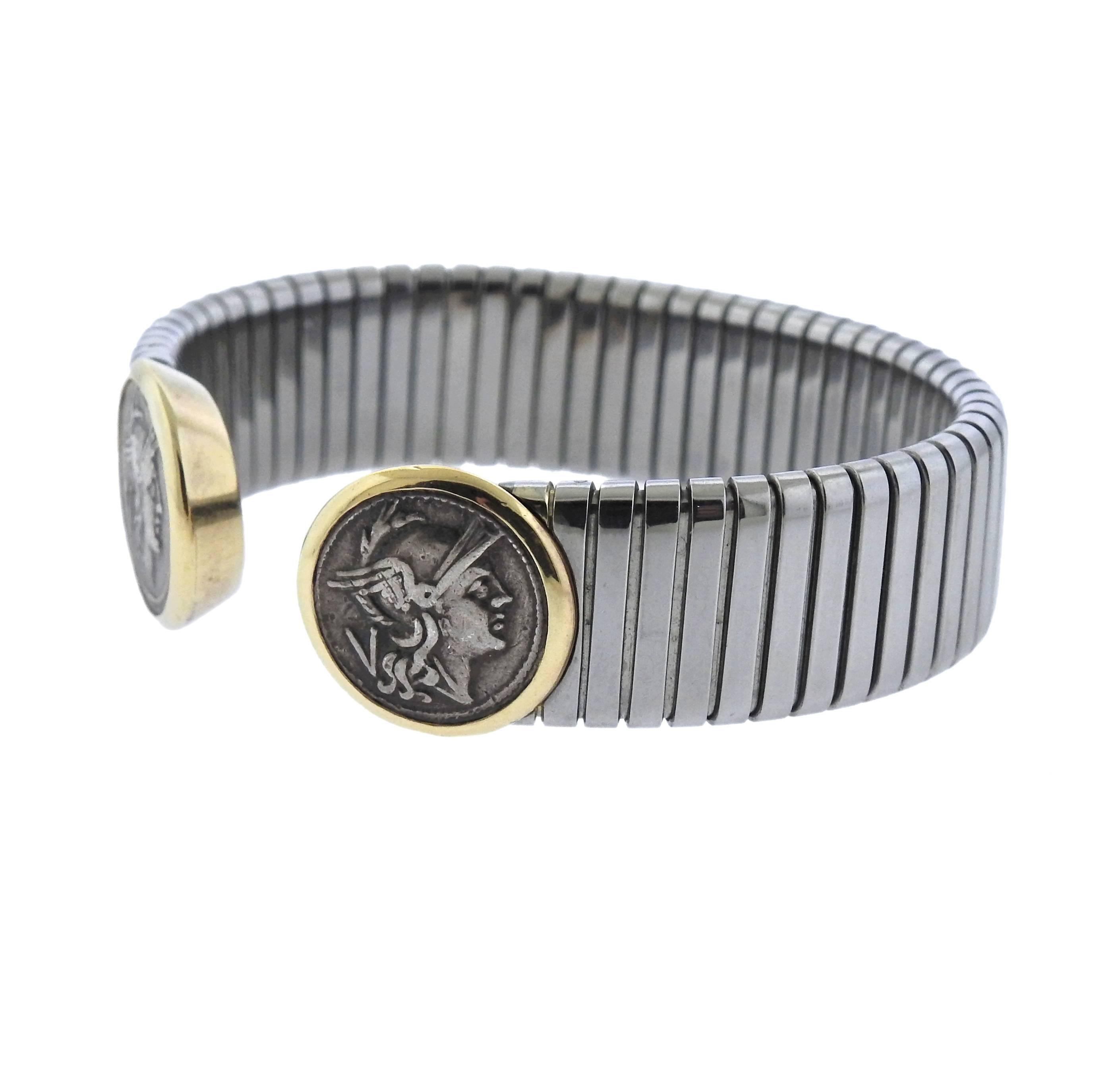 18k gold and stainless steel  cuff bracelet, crafted by Bulgari, set with two 15mm Ancient coins. Bracelet will fit approx. 6.75