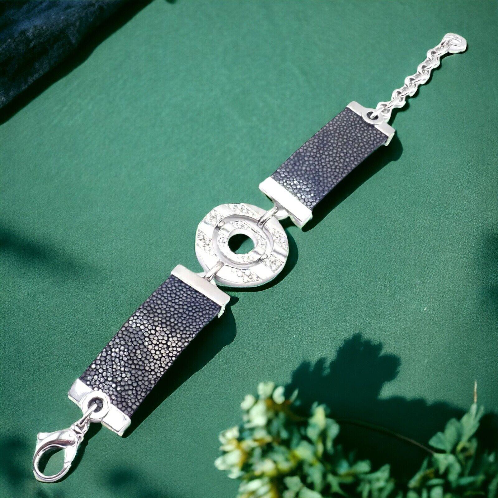 18k White Gold Diamond Astrale Shagreen Bracelet by Bulgari. 
The Bvlgari Bulgari Astrale 18k White Gold Diamond Shagreen Bracelet is an exquisite piece, featuring a dazzling array of diamonds set in 18k white gold. 
The bracelet's blackish gray