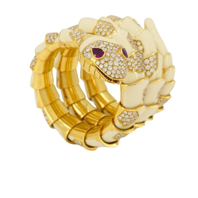 Designed as a coiled serpent, this Bulgari Serpenti watch is made from 18k gold, with each segment shaped to create a smooth fit around the wrist. The body is covered in glossy white enamel, incrusted by the gold hexagonal diamond set scales. The