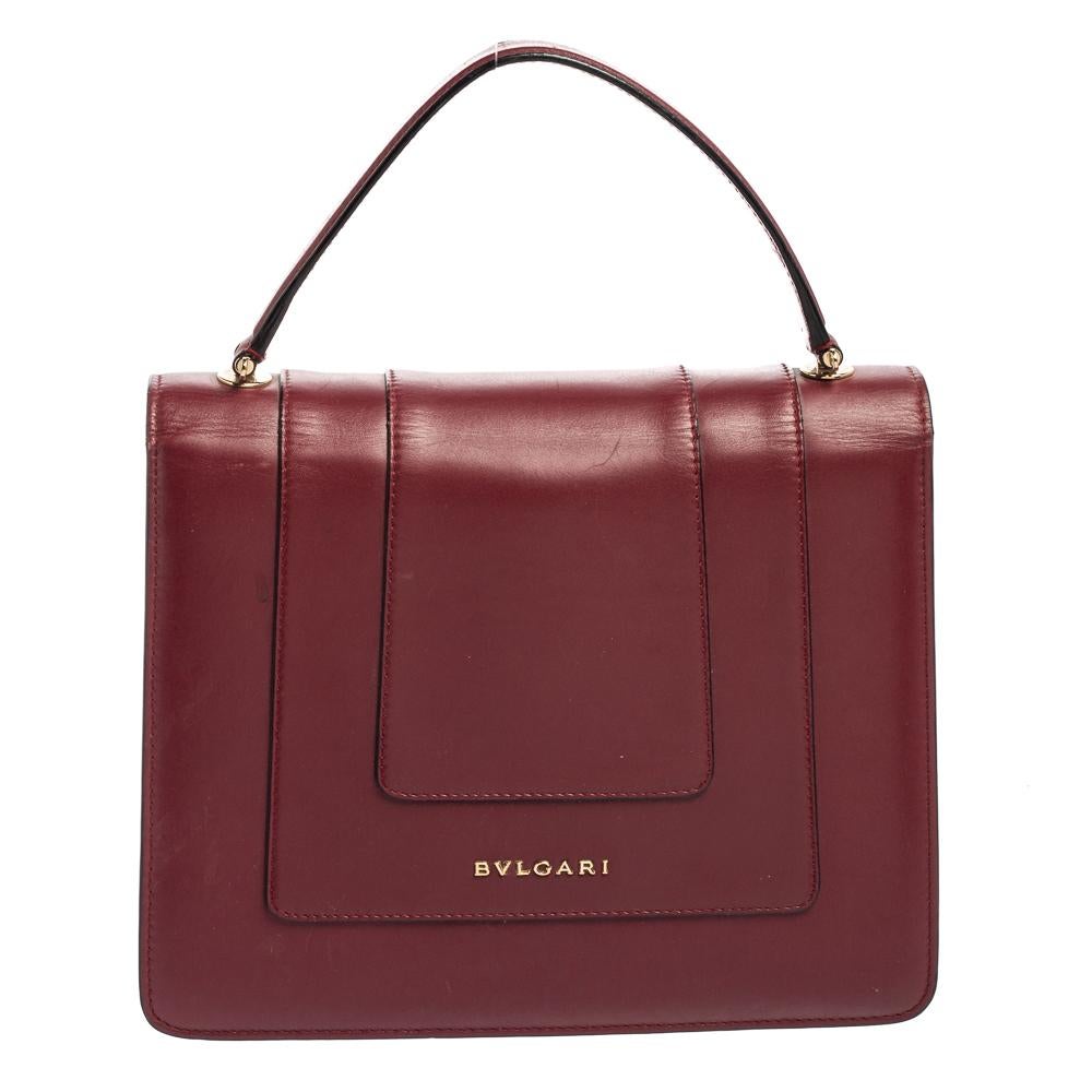Add a dazzling element to your style with this stunning Bvlgari creation. Crafted from leather, the bag has a flap with the iconic Serpenti head closure. It has a lined interior and a top handle for a hand-held carrying experience.

Includes: Pocket